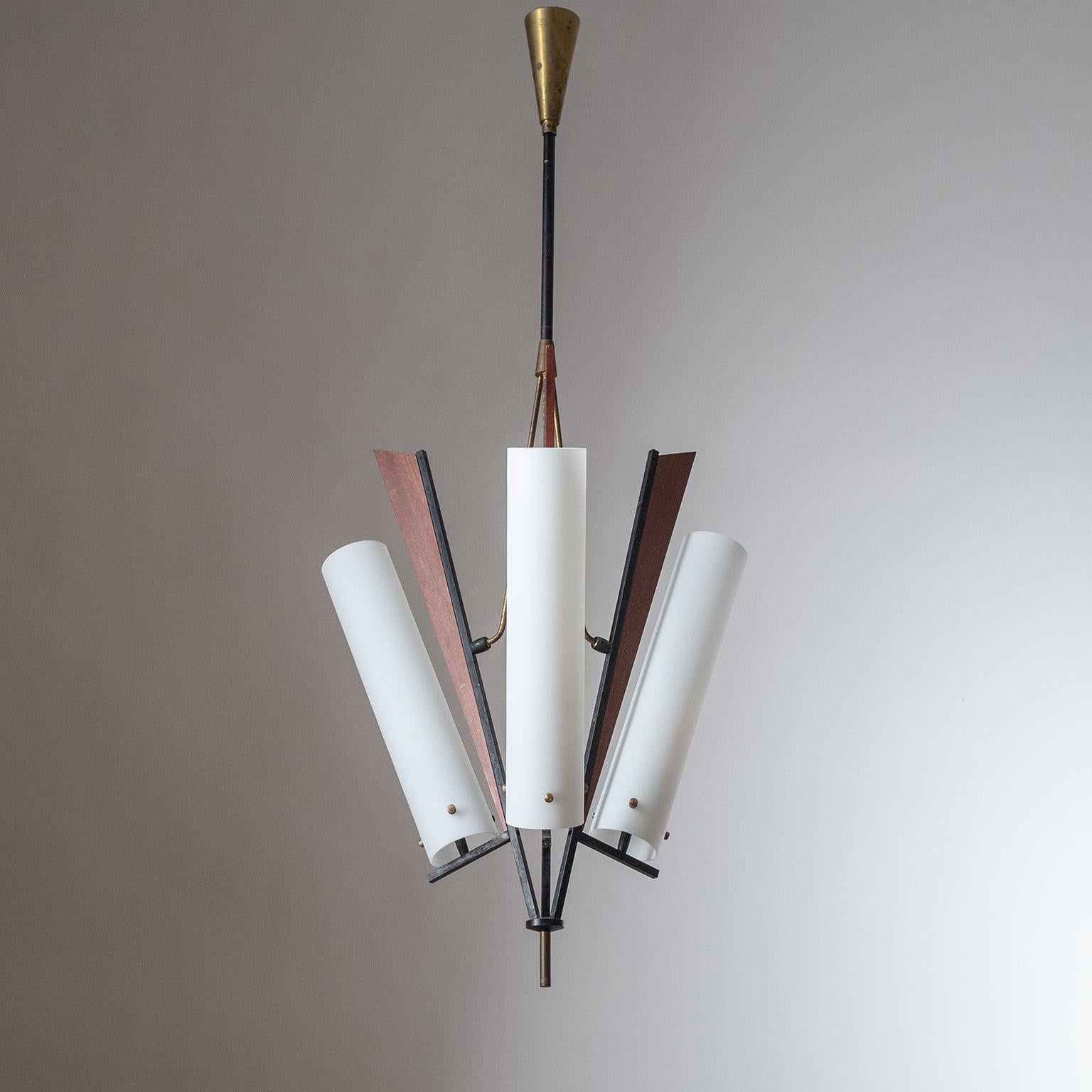 Rare Italian modernist chandelier from the 1950s. Very unique and dynamic three-arm structure made of lacquered brass with teak details. Long tubular diffusers made of 'triplex opal' glass. Three E14 sockets with new wiring.