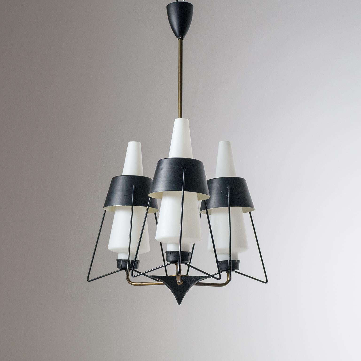 Very unique modernist Italian chandelier from the 1950s. Three brass arms each with a satin glass 'triplex opal' diffuser encased in Sputnik like structure with black lacquered shades. Fine original condition with patina on the brass and some light