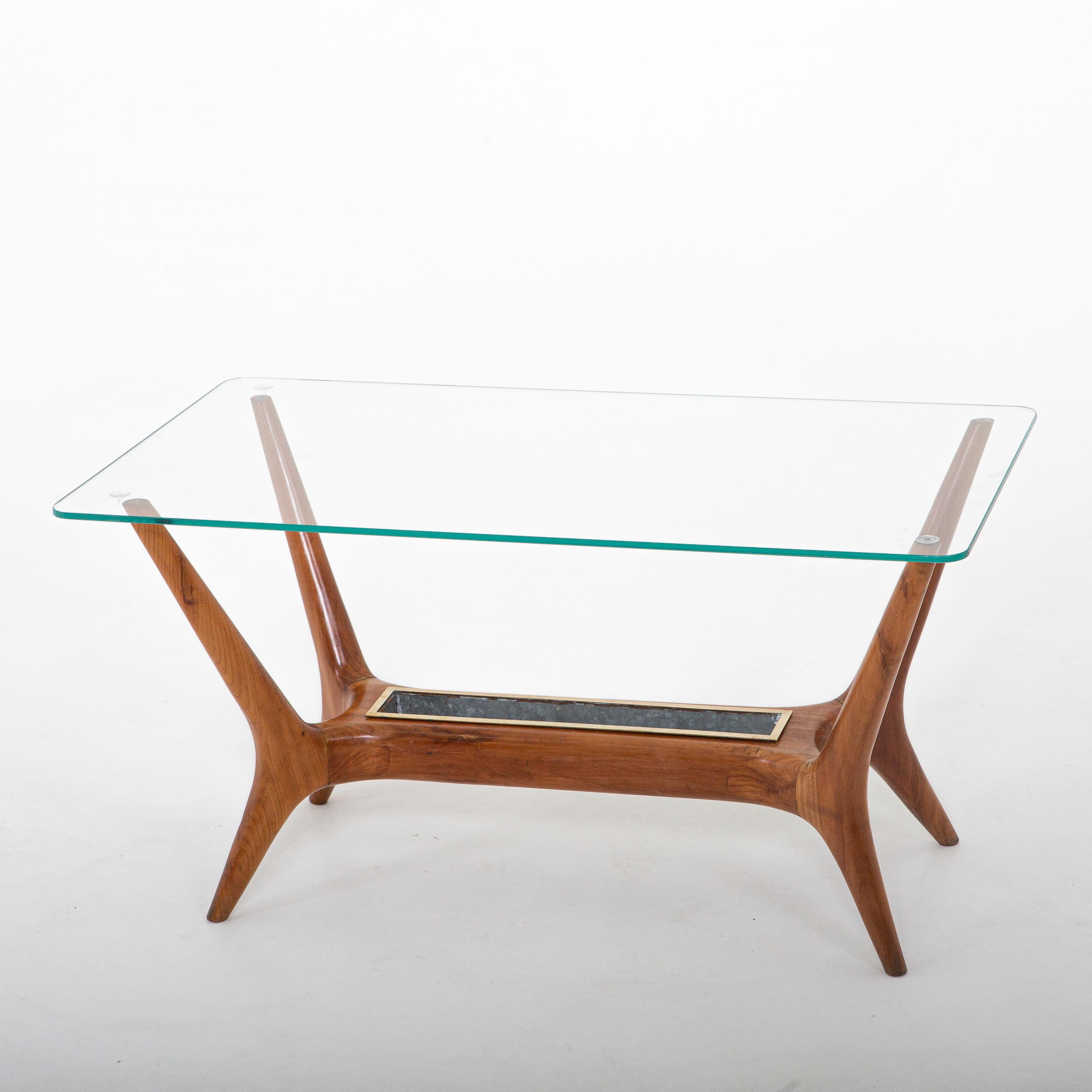 Italian modernist cocktail table attributed to Gio Ponti.
Walnut, glass top, brass planter insert.