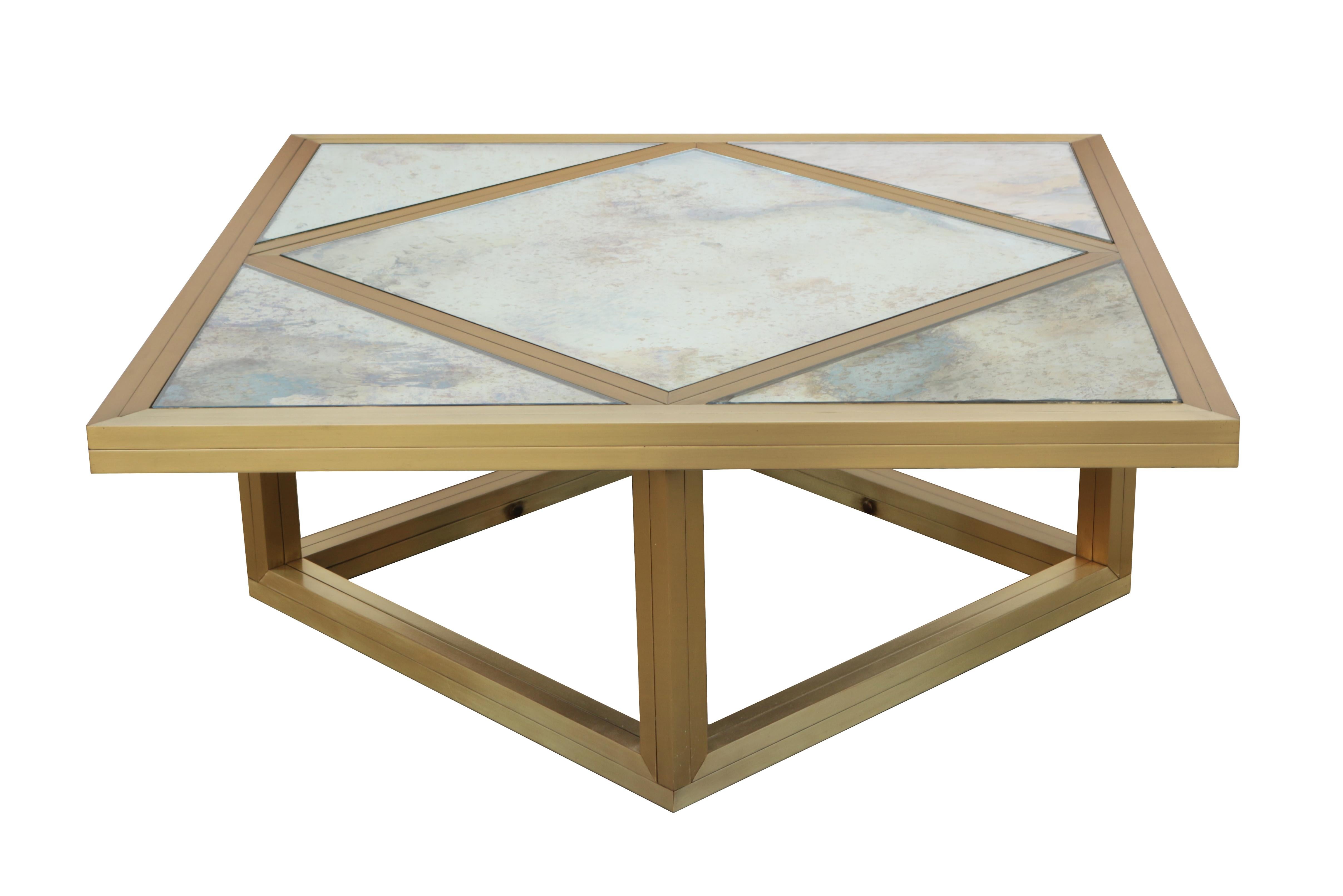 An Italian modernist cocktail table.
Geometric design in brass with
aged mirror glass segmented top.
 
