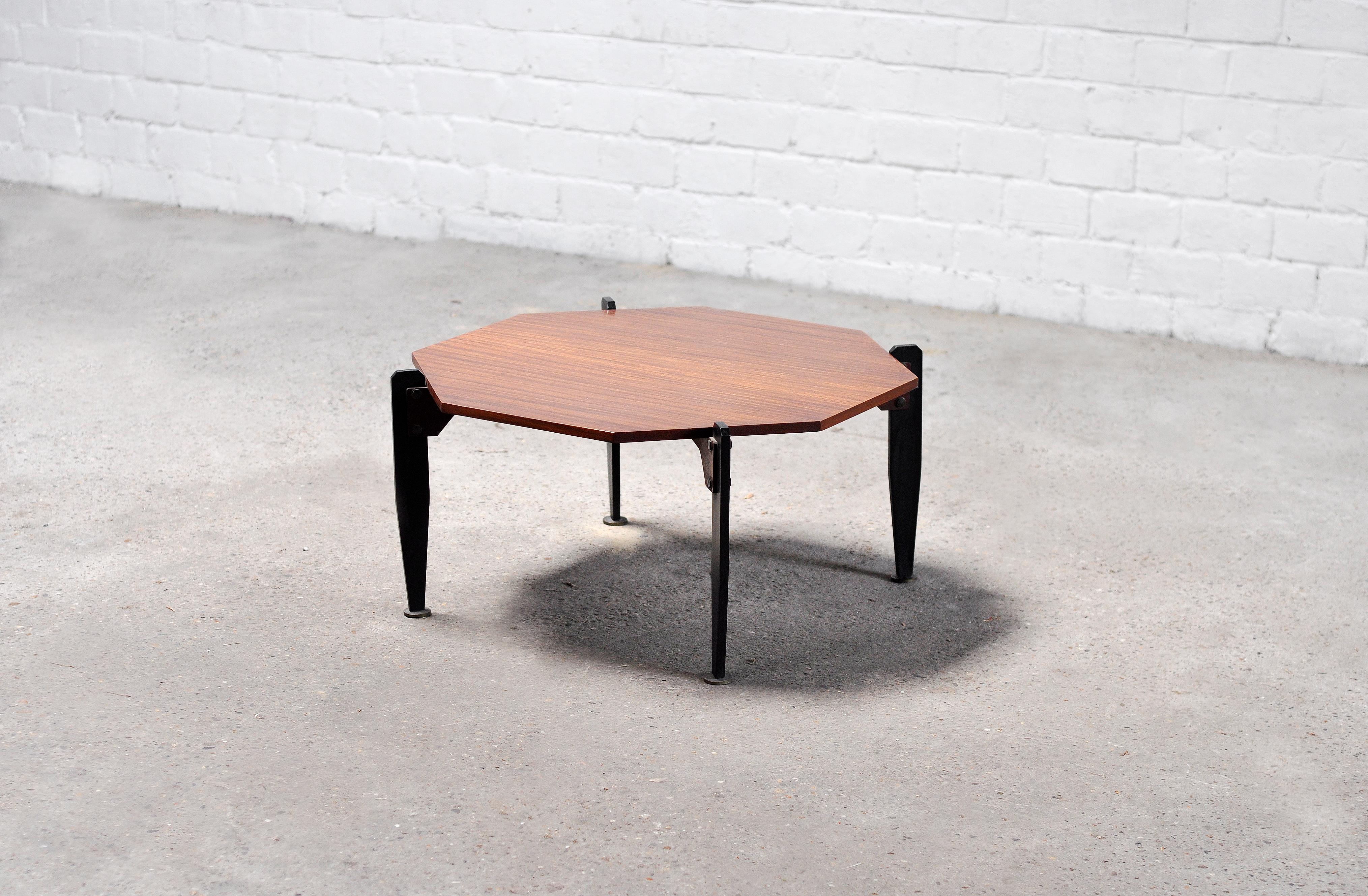 An early modernist coffee or cocktail table produced in Italy, 1950s. Executed with very elegant and typical modernist details including sculptural lacquered metal legs, an octagonal teak top, and round brass tips. This piece is yet to be