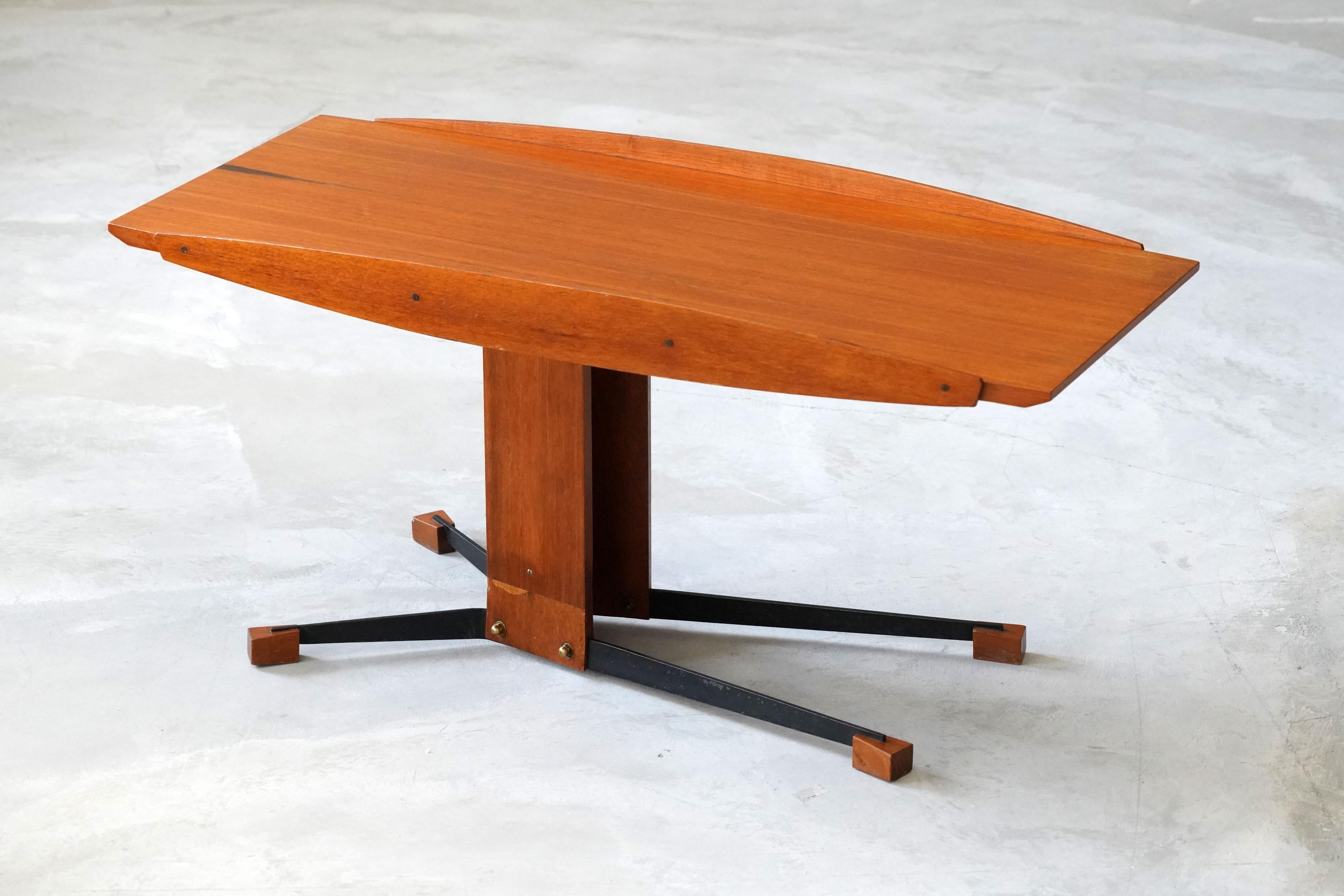 A modernist coffee table / cocktail table. Designed and produced in Italy, 1950s. Executed in stained metal, brass and teak. Can also be utilized as an occasional or end table.

Other designers of the period include Gio Ponti, Ico Parisi, Franco