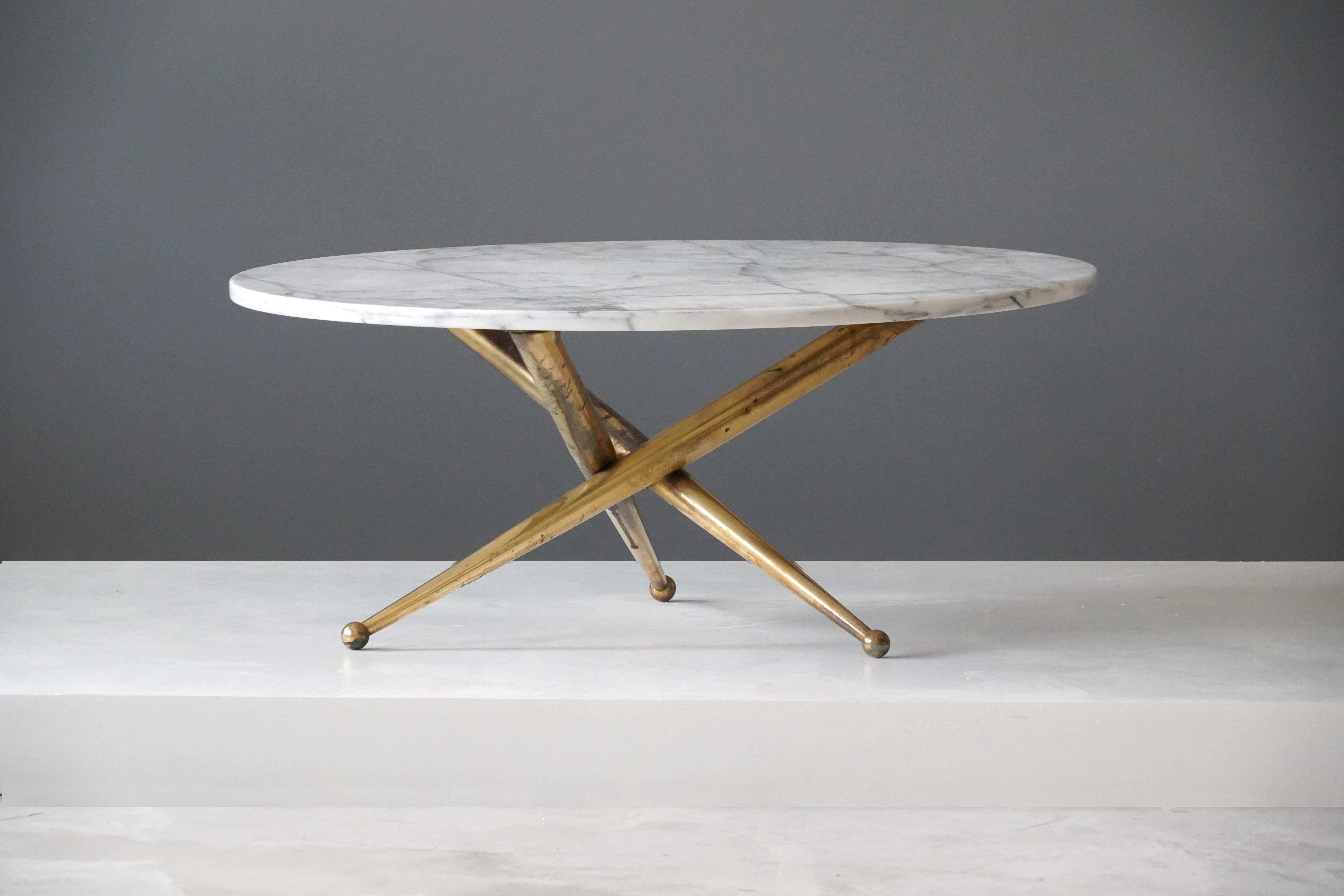 A coffee/cocktail table on tri-legged base. Top in Carrara marble. Designed and produced in Italy, 1960s. Base marked 