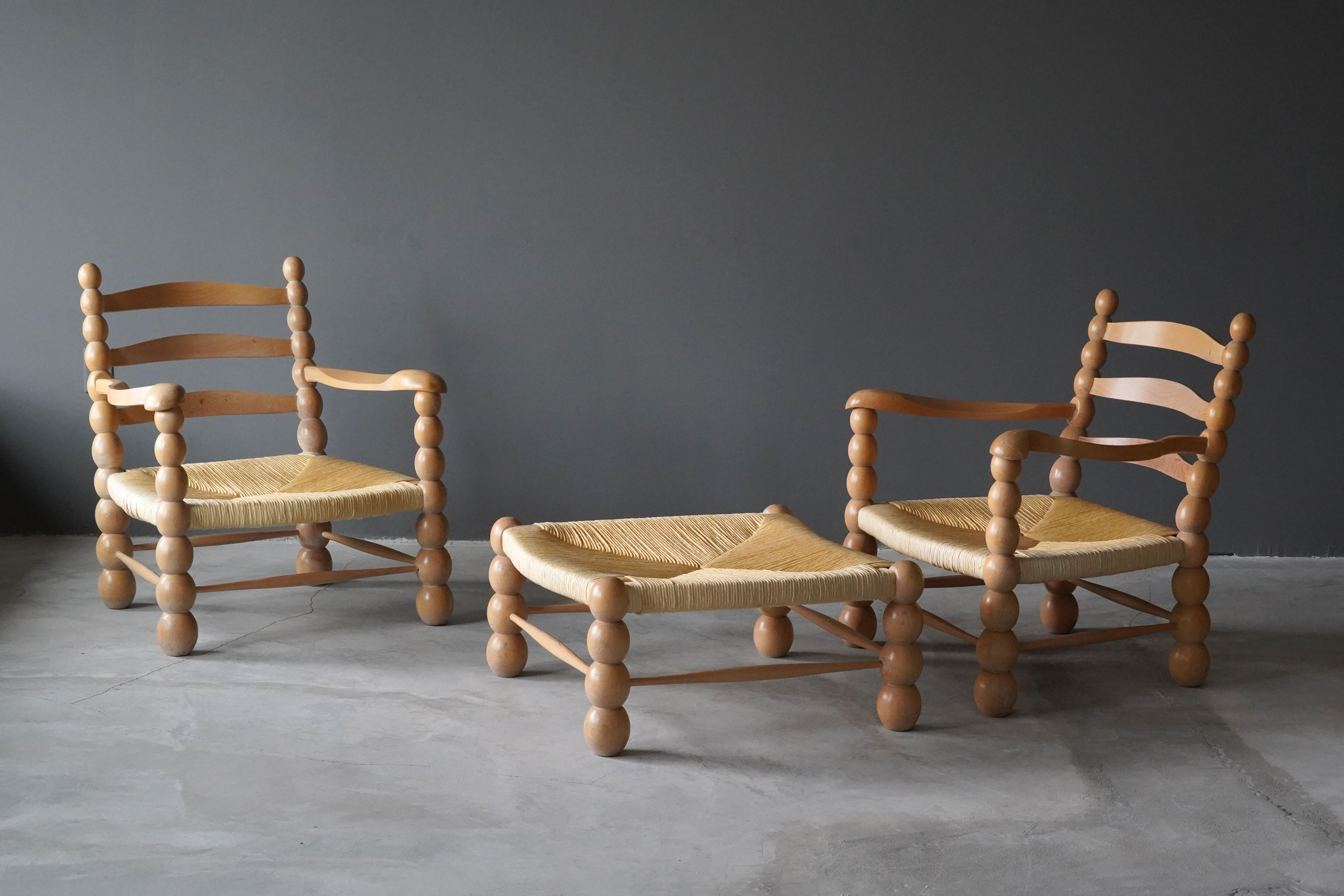 A pair of lounge chairs / armchairs. Executed in finely carved European beech and rattan. Produced in Italy 1960s. Expresses a visual language similar to that of works by Paolo Buffa or Jean Royere.