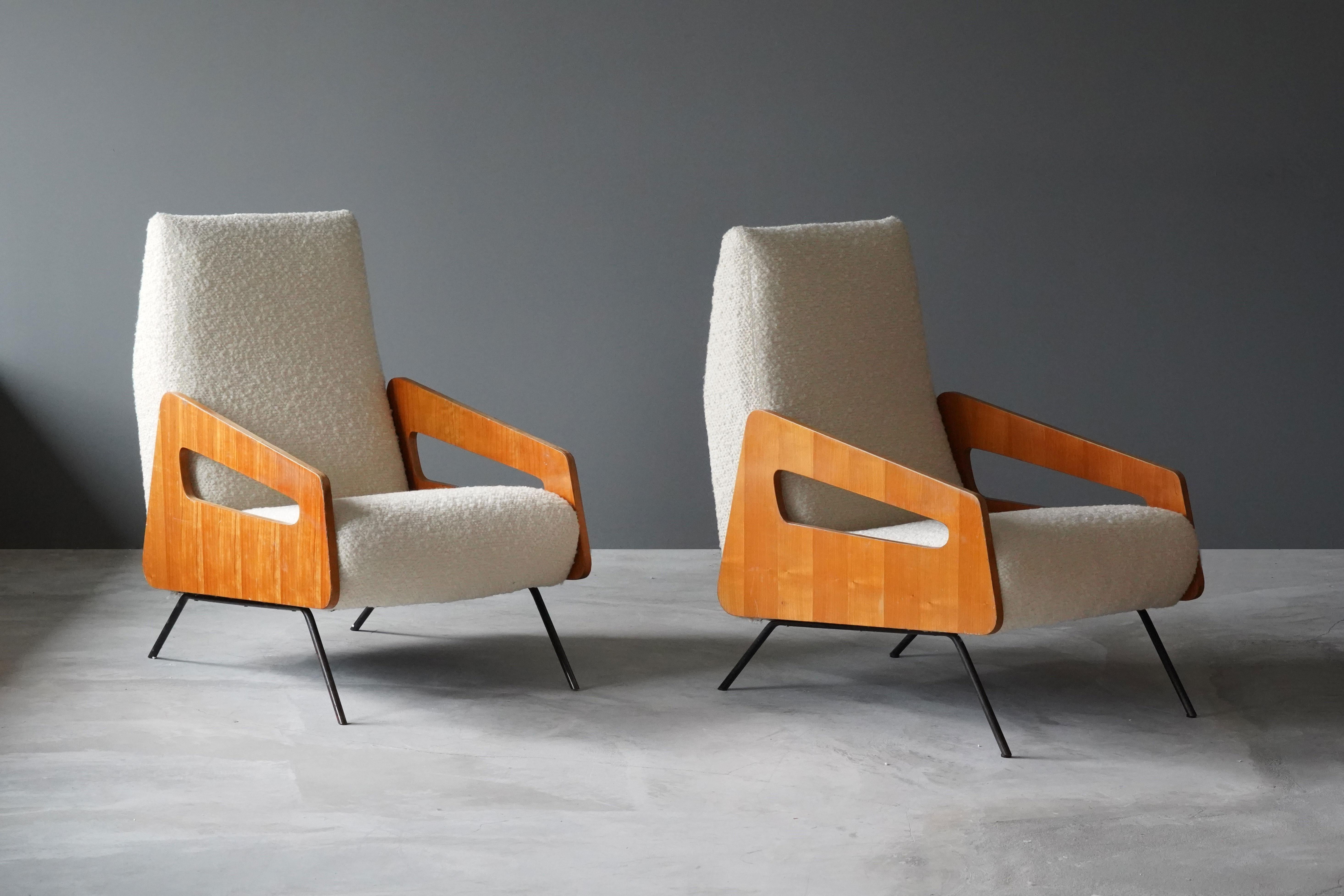 A pair of highly modernist lounge chairs. Designed and produced in Italy, 1950s. Features an interesting mix of materials, brand-new white high-end bouclé, wood, and lacquered steel.

Other designers of the period include Gio Ponti, Franco Albini,