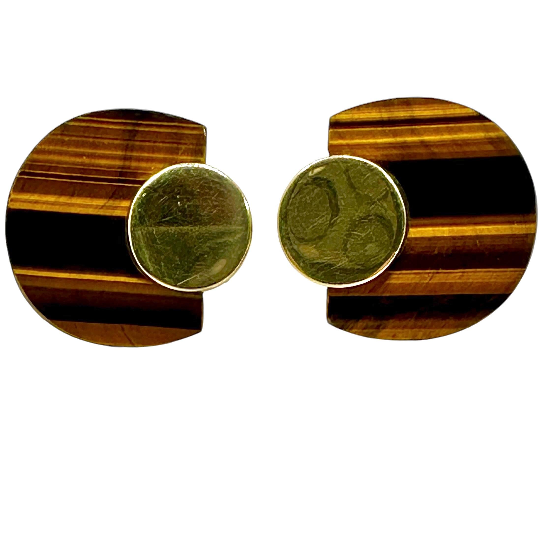 This imaginative and striking pair of Italian 18k yellow gold and Tigers-Eye earrings are both tailored and elegant. A 12.5mm gold disc sits atop a horse shoe shaped panel of Tigers-Eye on each earring, creating a very interesting look that is