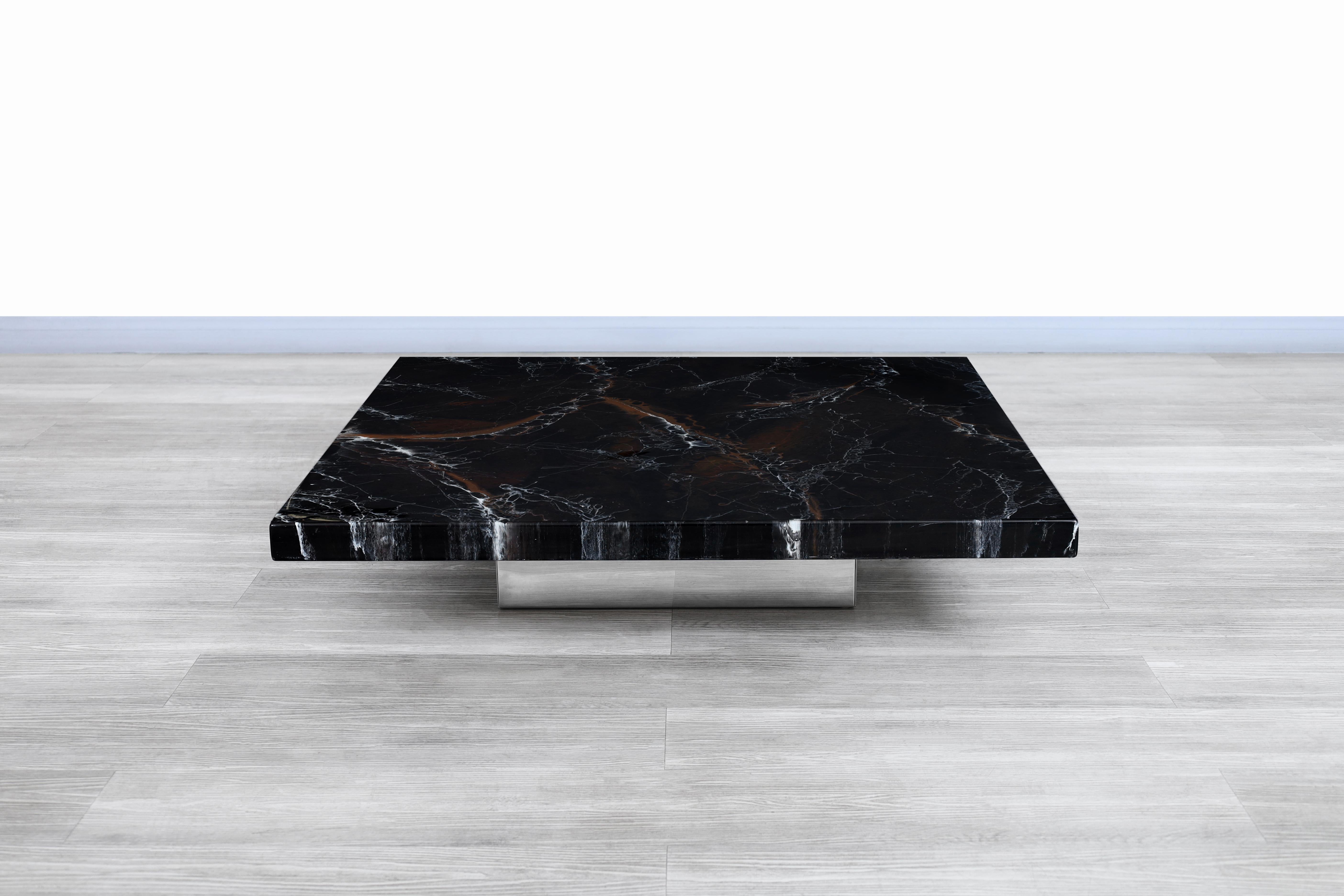 Stunning vintage Italian cocktail table designed by Willy Rizzo, circa 1970s. This table has an organic and minimalist design in which the elegance of the materials used in its construction stands out. Features a faux marble top that gives a unique
