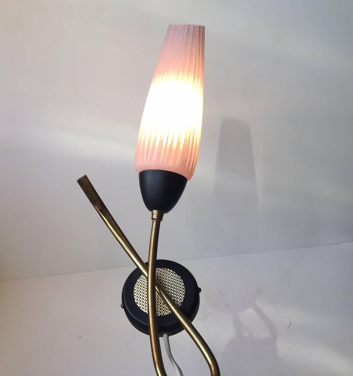 Flower shaped sconce designed in a style reminiscent of Stilnovo and manufactured during the 1950s by Eleltrik in Italy. It is made from brass, matte black powder coated metal and striped purple glass. When lid the shade changes color from purple to