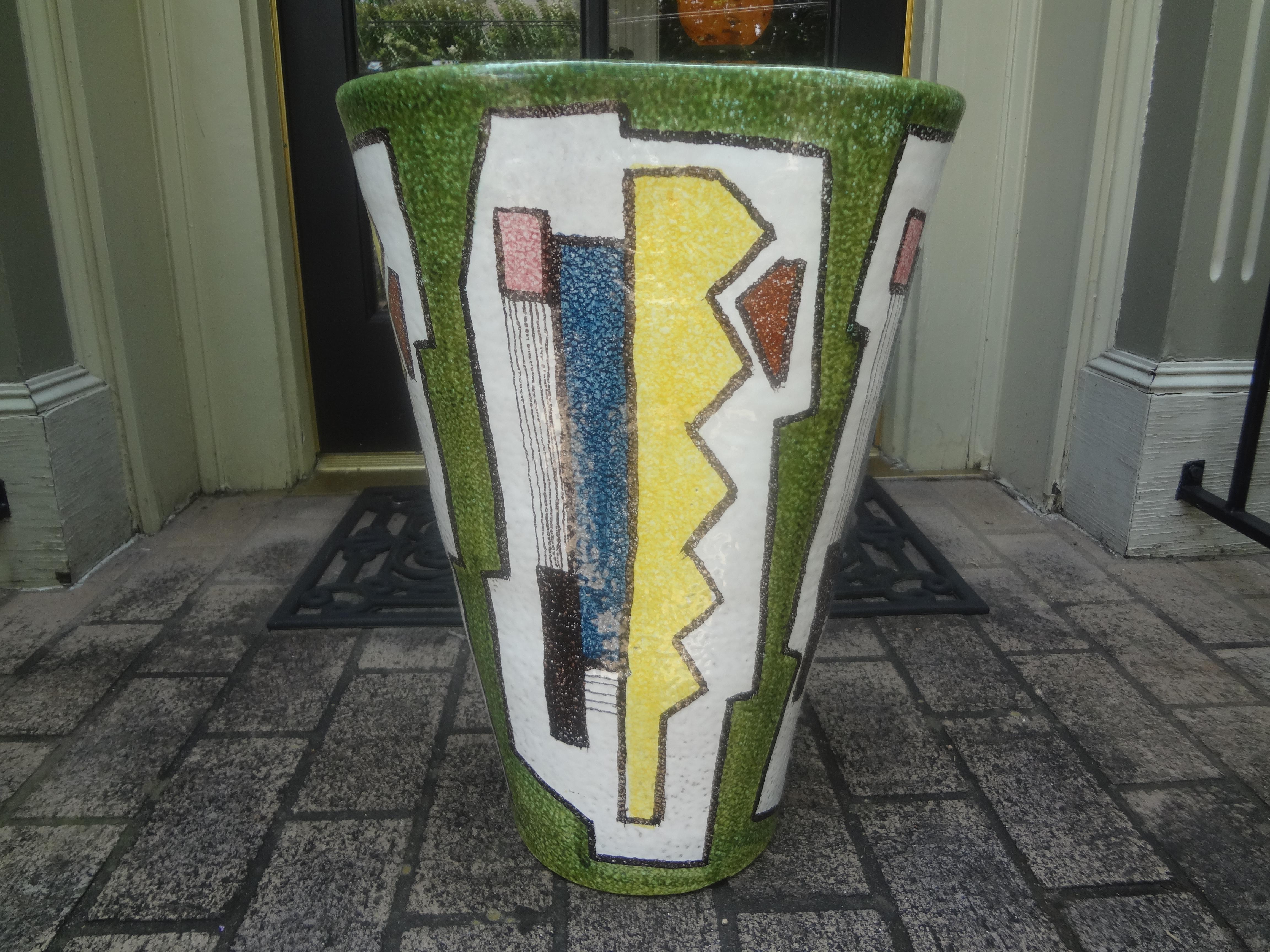 Italian Modernist Glazed Ceramic Umbrella Stand.
This stunning Italian Modernist umbrella stand or vase was realized in Italy, circa 1970. This piece features a bold geometric pattern of blue, white, yellow, pink, green and black in a beautiful