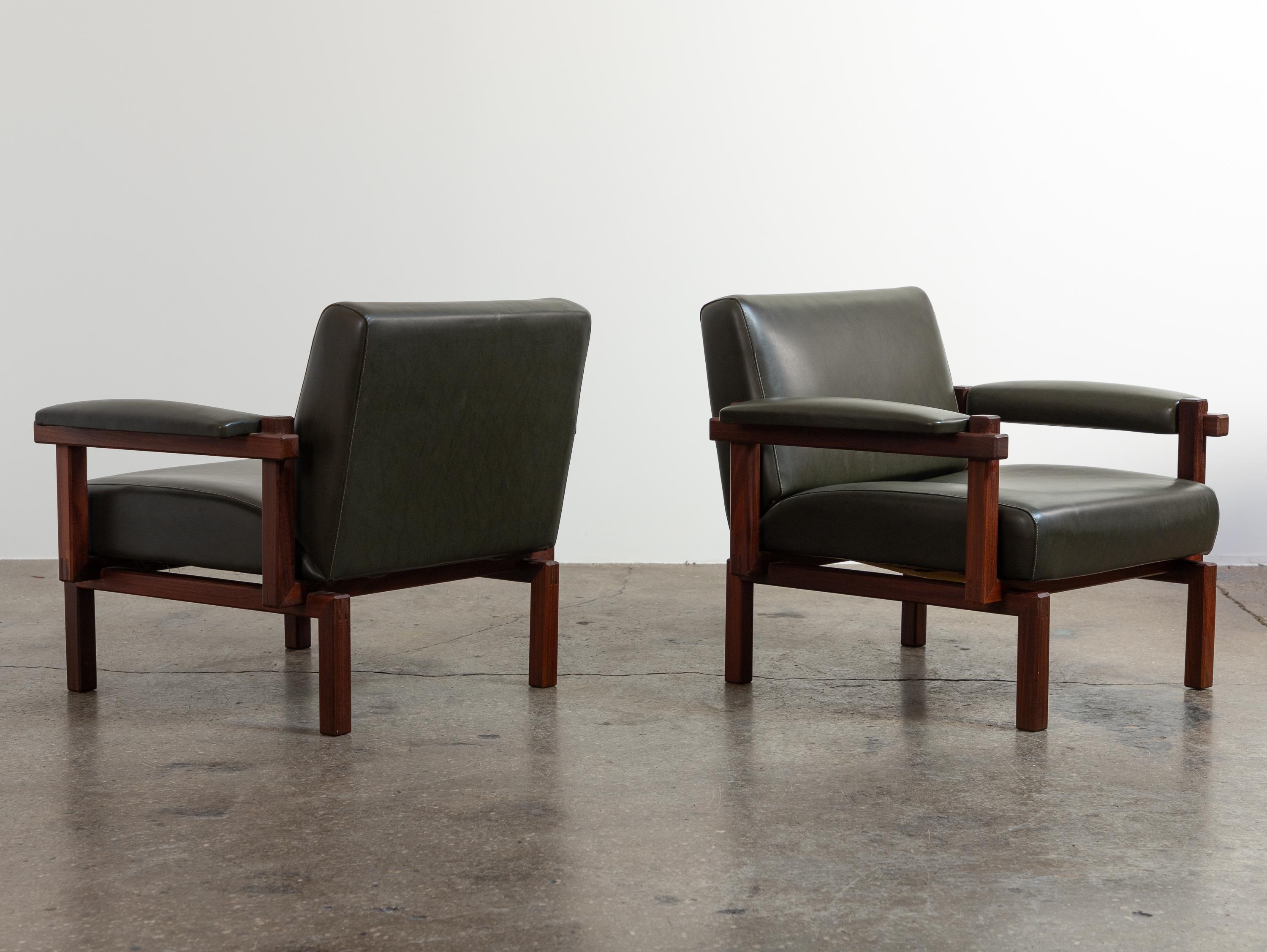 Wonderful pair of Grazia lounge chairs, designed by Raffaella Crespi for Elam. Crafted from fine Italian walnut, the open-frame design showcases an intriguing constructivist influence. These elegant chairs feature a low profile and generous cushions