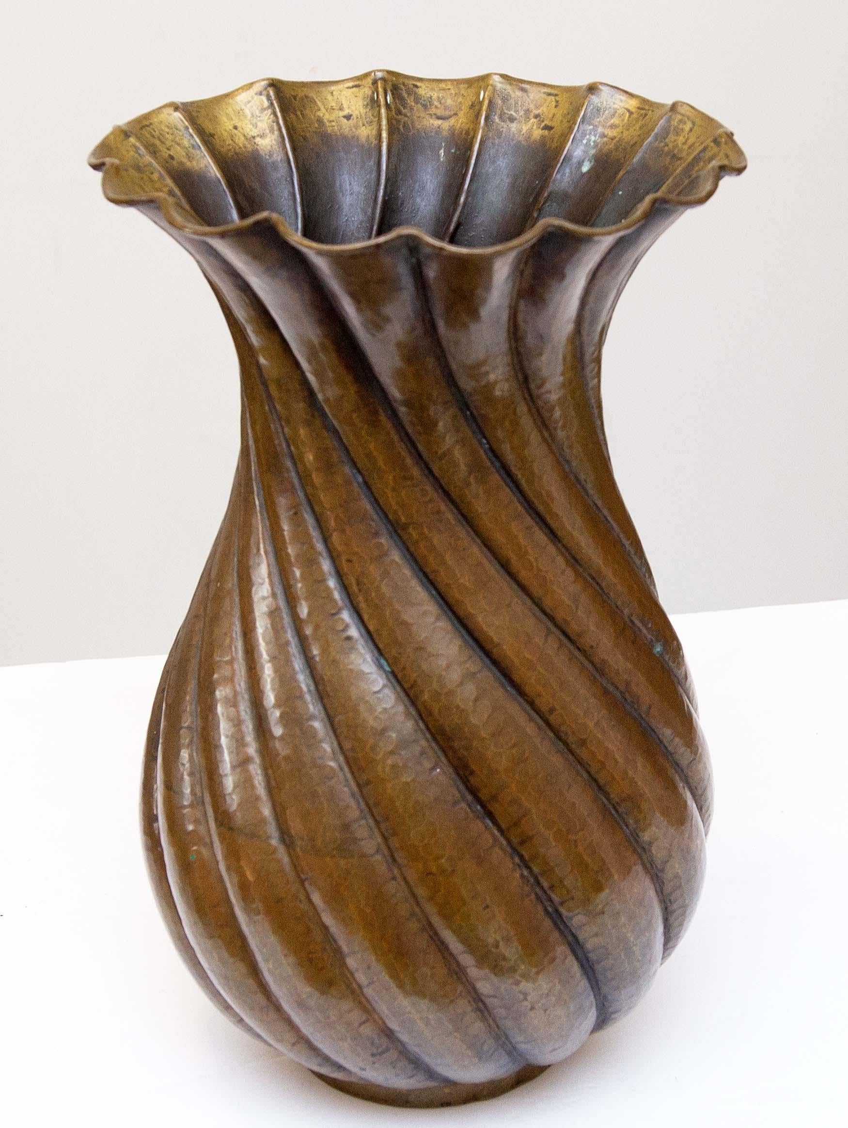 Italian modernist hammered copper vase decorated with spiraling lobes made by Egidio Casagrande. Rich bronze patina, circa 1940s.
Egidio Casagrande (1911-1962).
He worked in brass and copper. He was born in Borgo Valsugana, Italy, in the northern