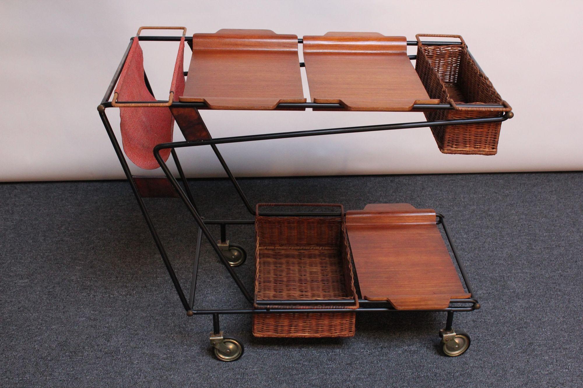 Unique drinks cart / trolley composed of a wrought iron frame with mixed metal inset panels accessorized with plywood trays and wicker baskets, all supported by caster wheels (ca. 1950s, Italy). Inserts can be configured in different ways, as shown,