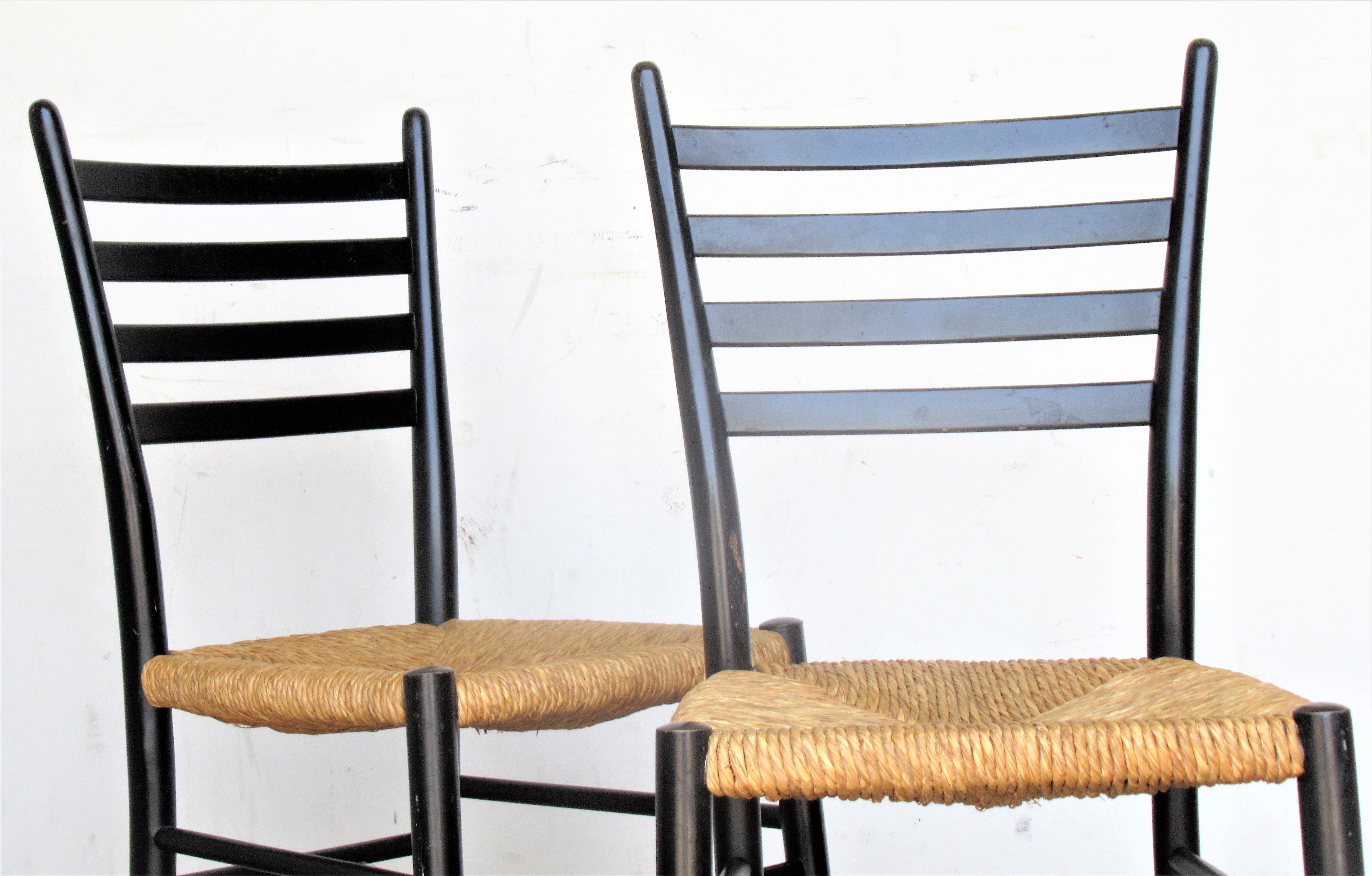 A pair of 1950's Italian modernist ladderback chairs in the style of gio Ponti, with the original woven natural rush seats and black lacquered factory finish. Look at all pictures and read condition report in comment section *****These chairs can be
