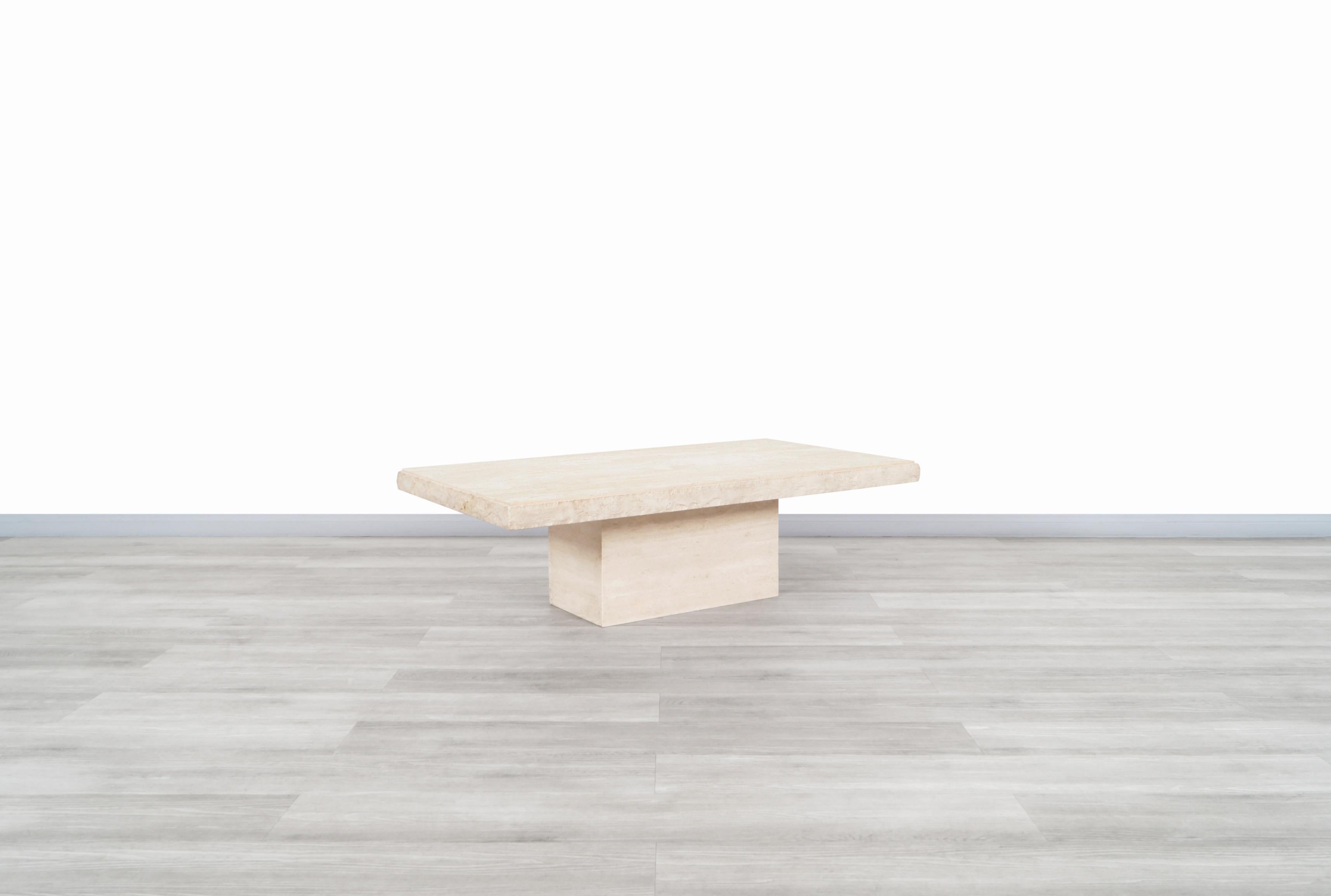 Fantastic vintage Italian modernist travertine coffee table designed and manufactured in Italy, circa 1970s. The combination of the natural minerals that make up the travertine stone flows beautifully through the entire table. The tables feature a