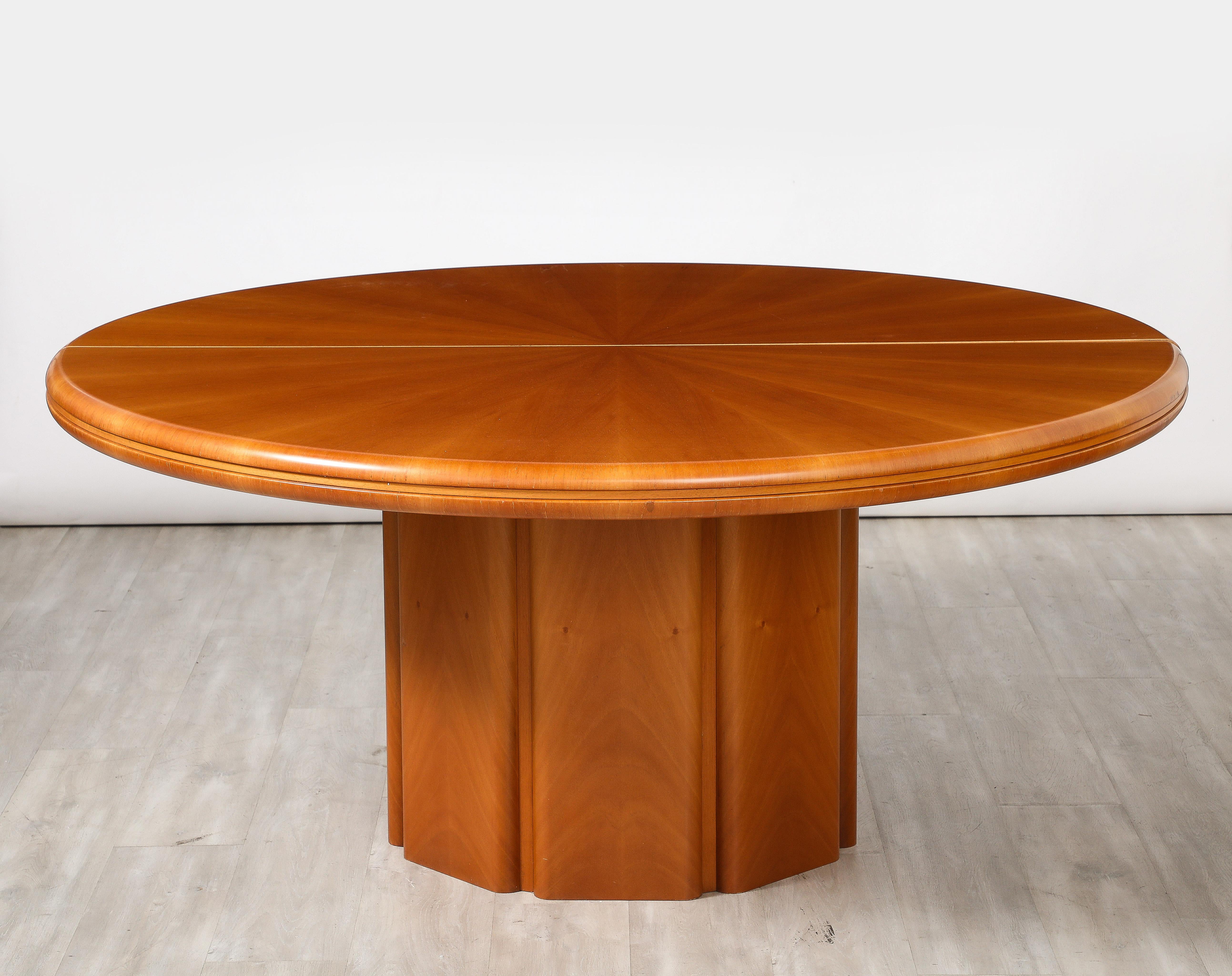 An Italian modernist dining or center pedestal table in maple wood.  The table top with a beautiful sunburst patter, the pedestal base is constructed with a faceted design.  Dramatic in size, it can be used as a center table or dining table. 
Italy,