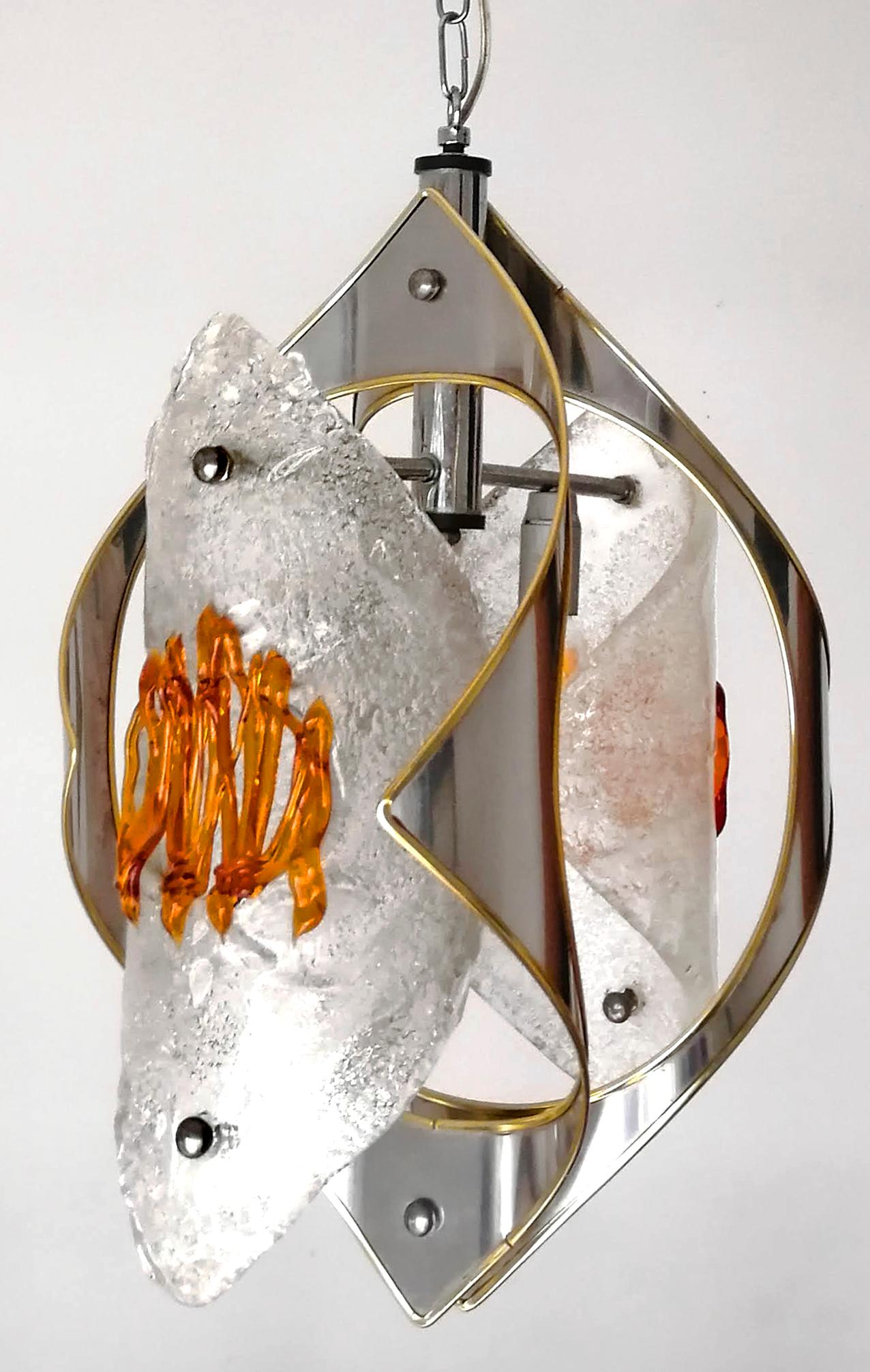 Mid-century amber Murano chandelier Mazzega by Toni Zuccheri was made in Italy in the 1970s. The glass parts are made of blown-thick Murano glass that has amazing colors. 
Dimensions:
Height 39.38 in.(chain 11.81 in)/ (100 cm (chain 30 cm))
Width