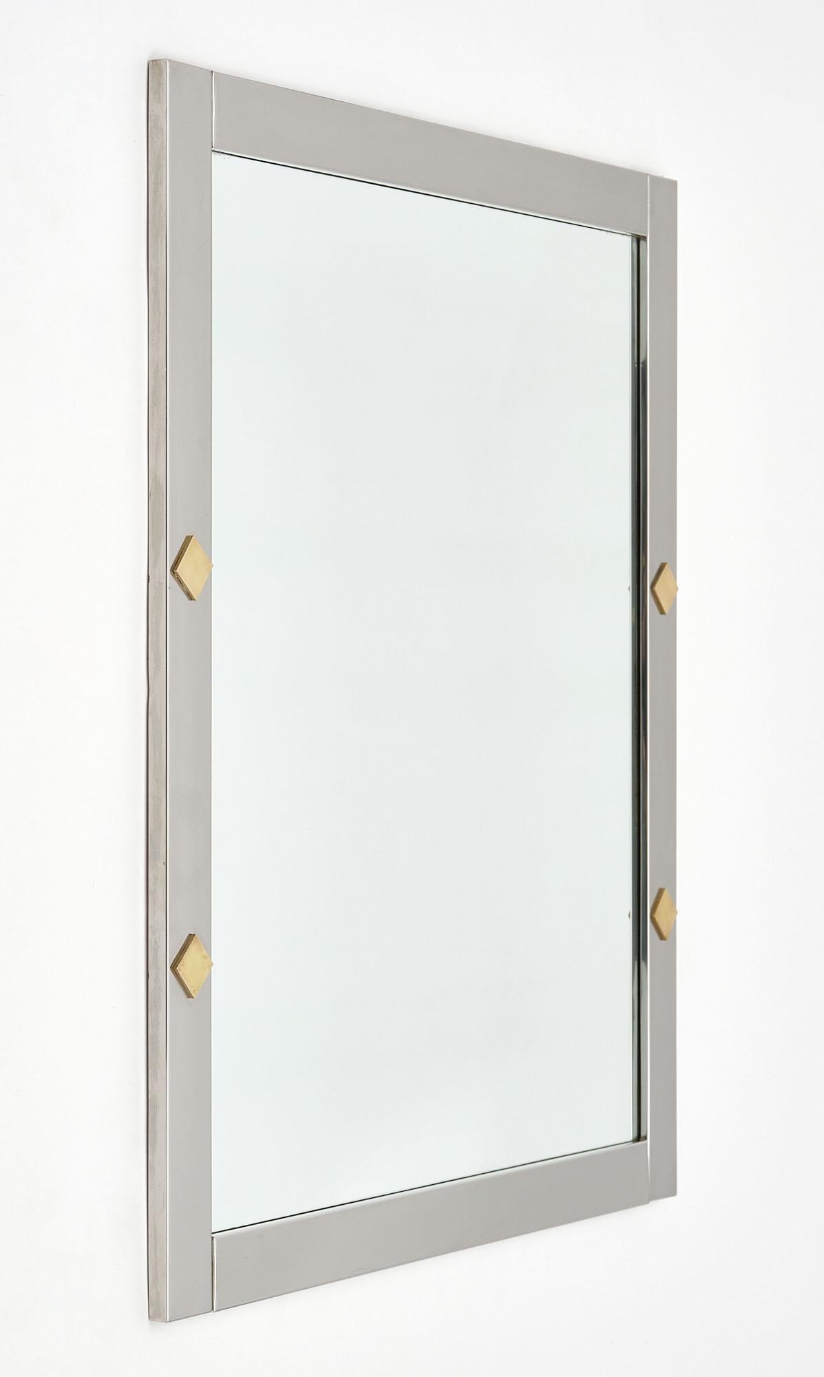 Pair of mirrors in the Italian modernist style. This pair is made of chromed steel with brass accents.