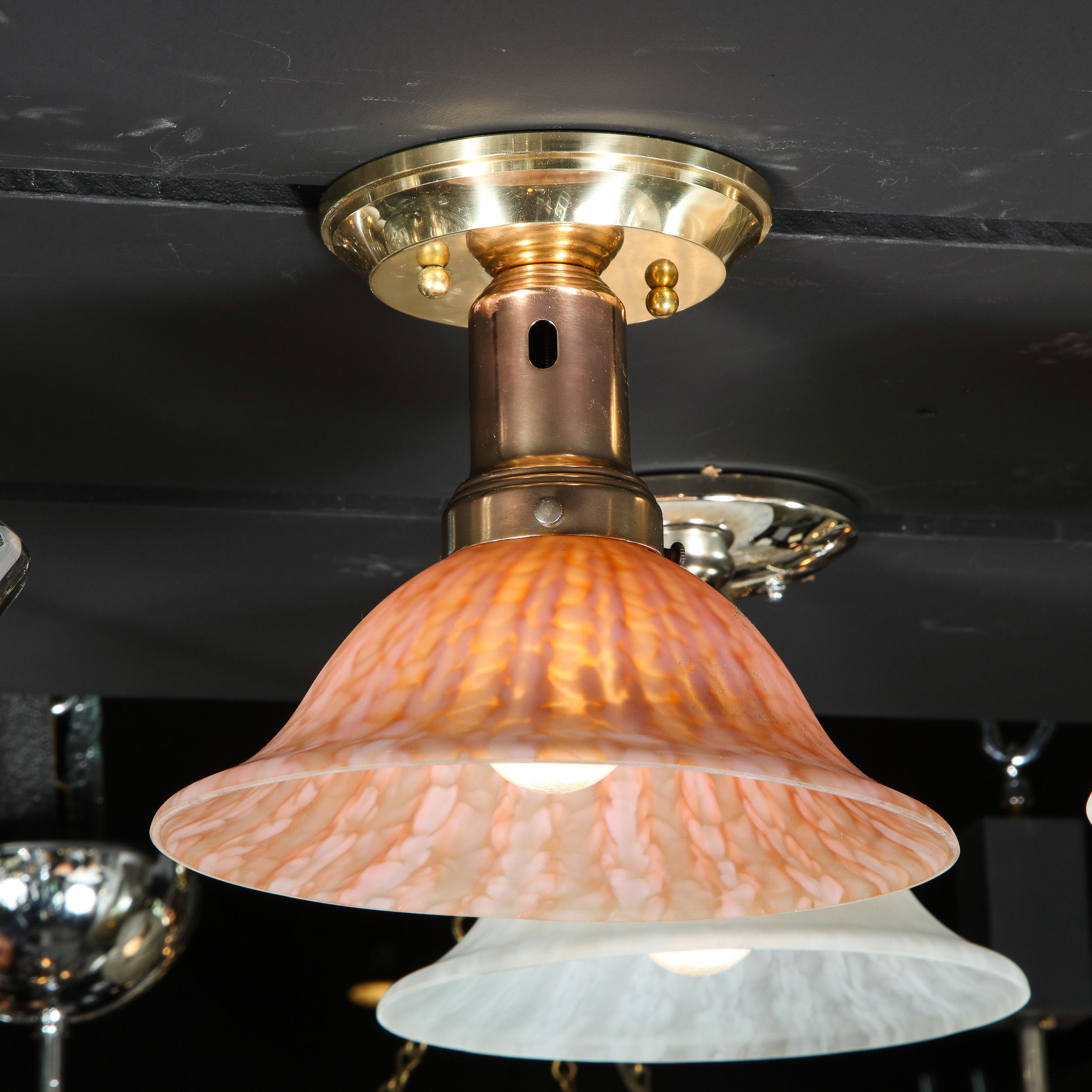This refined modernist flush mount was realized in Murano, Italy- the island off the coast of Venice renowned for centuries for its superlative glass production- during the 20th century. It features a billowing convex shade in mottled sherbert glass