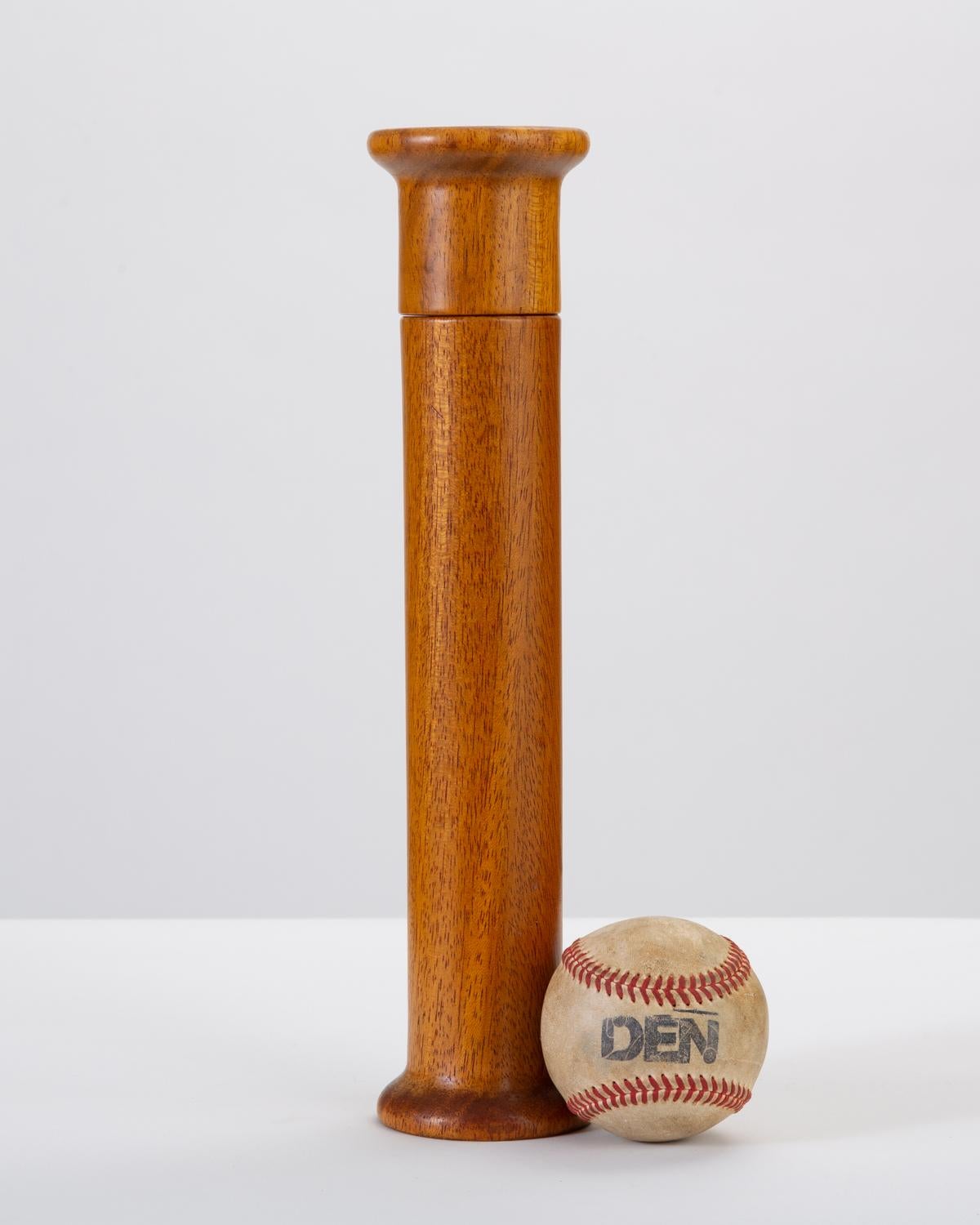 A tall, midcentury pepper mill from Italy with a columnar form, widening at either end. Made from beautifully aged oakwood, this item displays subtle grain figuring and plenty of darker rays. A single screw at the rotating upper portion secures the