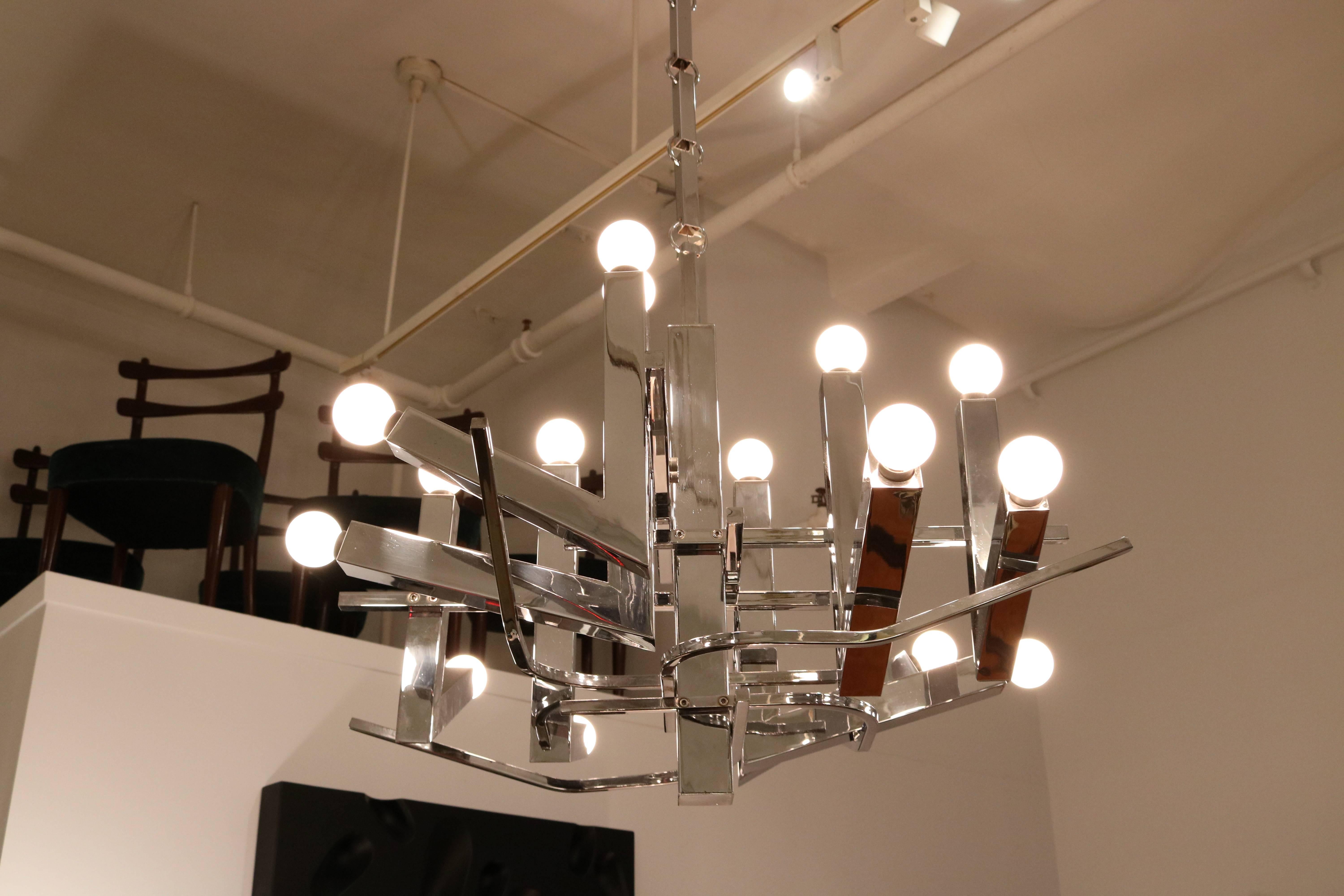 Sculptural Italian Modernist sixteen light chandelier.
Chromed metal finish with sixteen candelabra base sockets.
Features original chain with a length over five feet long.
THIS FIXTURE IS NOT UL WIRED.