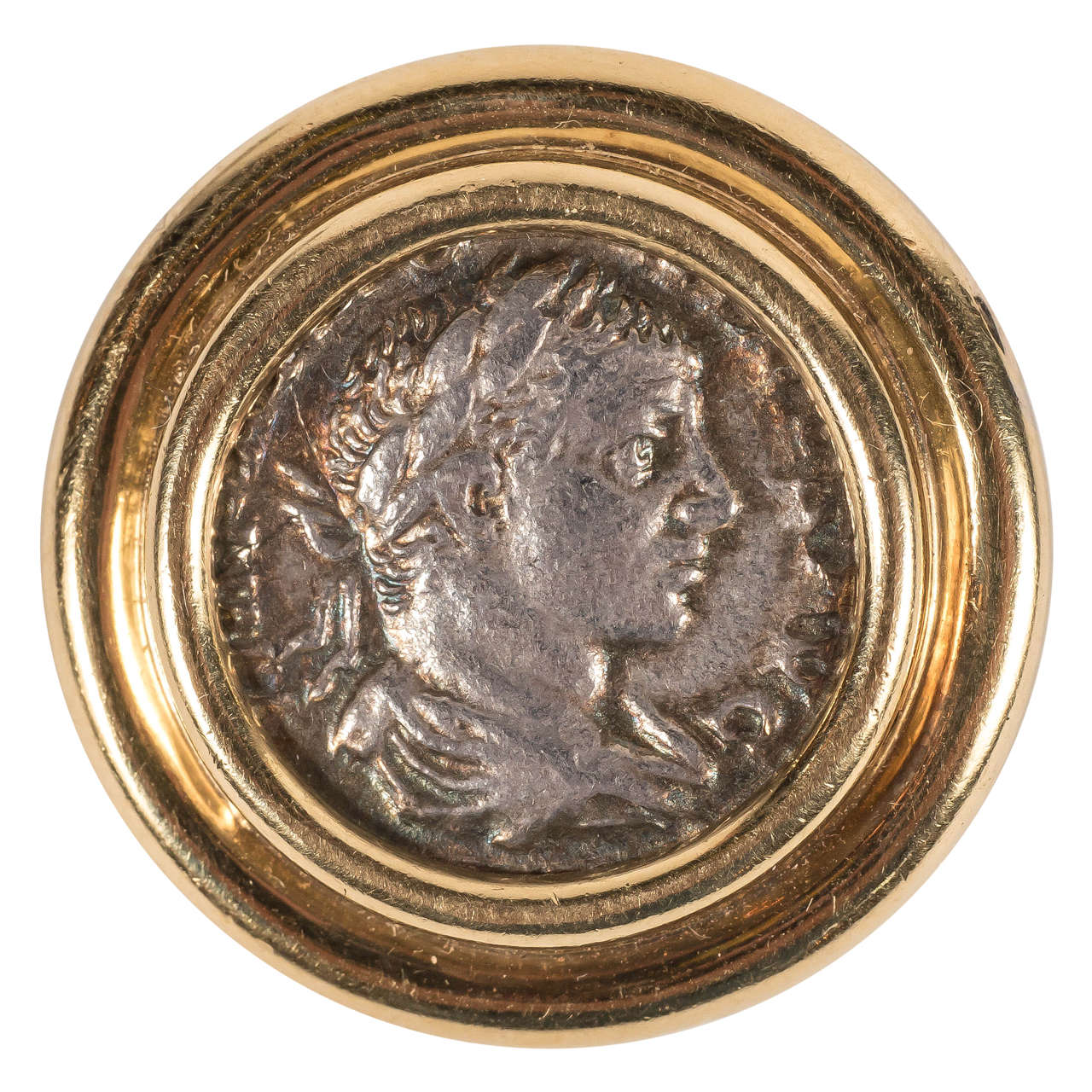 This ancient Roman coin was set in a 18k yellow gold slide in Italy, circa 1970- fusing the ancient and the modern. The piece offers stepped ribbed detailing giving added dimension to the focus of this inset coin. With its beautiful attention to