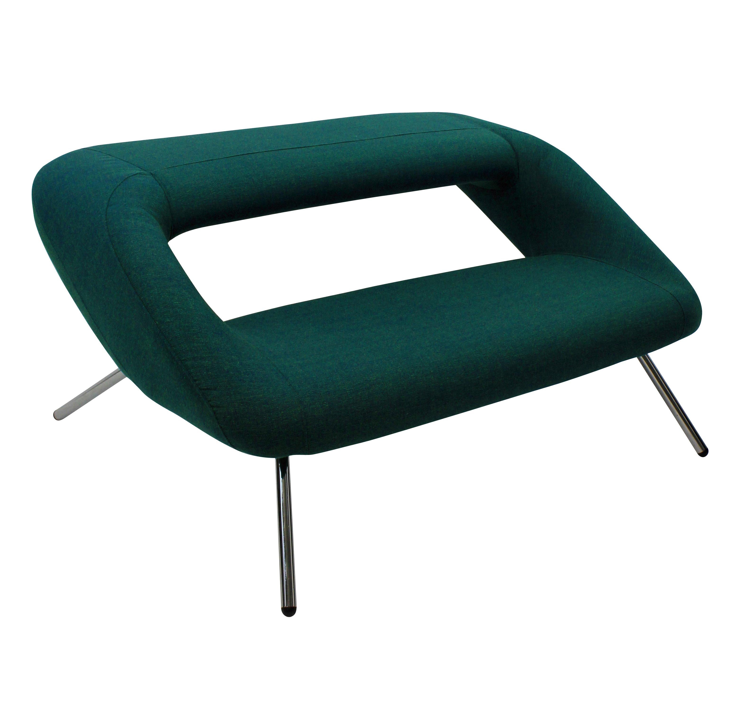 An unusual Italian modernist sofa. Of interesting design, newly upholstered in emerald bute and on chrome legs.
 