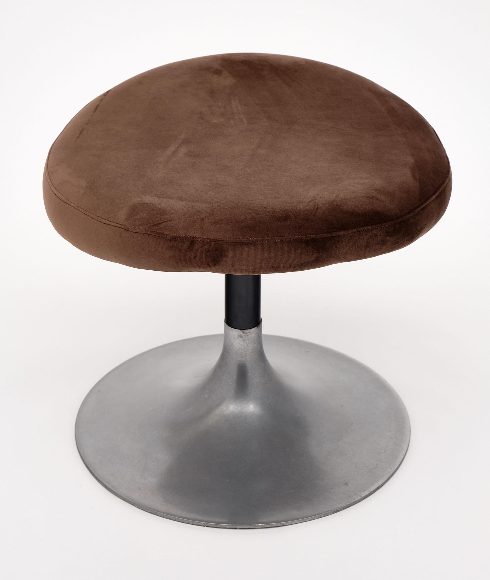 Pair of stools from Italy. Each modernist stool has a circular base of aluminum alloy. The curvilinear seat has been newly upholstered in a chocolate brown. Originally a set of four (as pictured) though only the dark brown stools are still available.