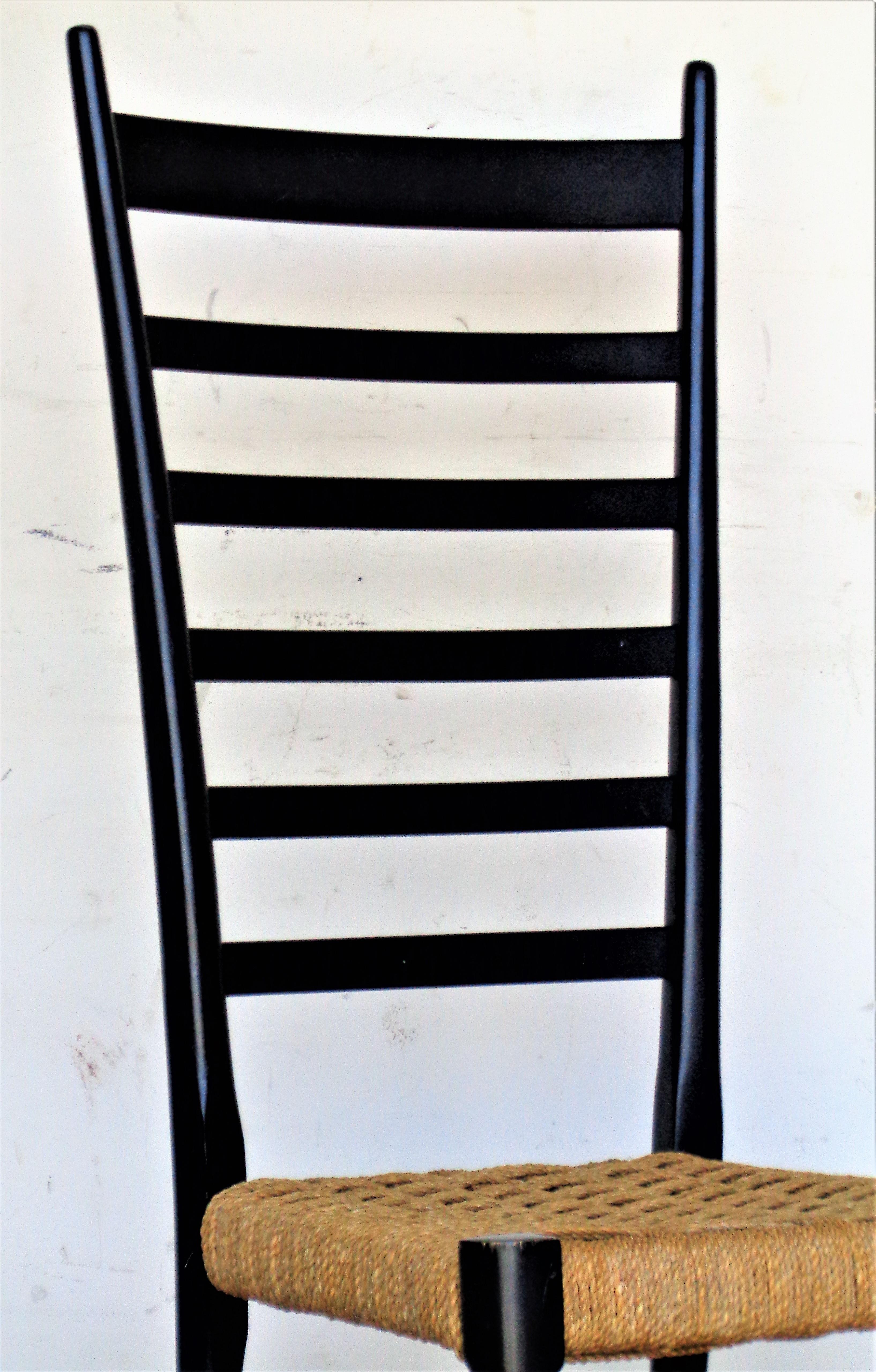 Gio Ponti superleggera style tall modernist ladderback chair in very good all original black lacquered finish and woven rush seat. Gold decal stamped on inner side rail - Made in Italy. Circa 1960. Look at all pictures and read condition report in