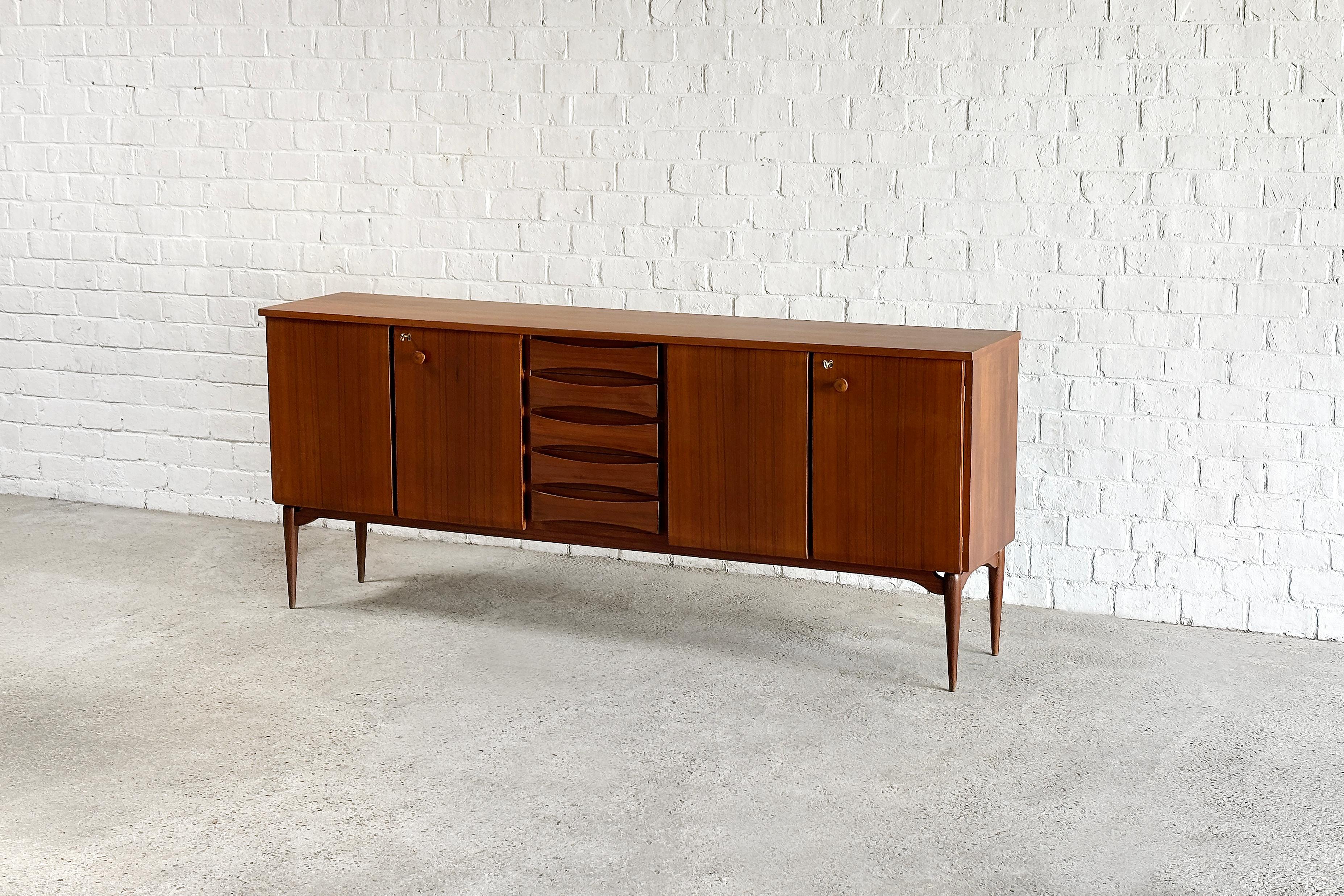 Beautifully constructed Italian modernist sideboard, designed and produced in 1960s. This piece is attributed to Vittorio Dassi. Crafted from fine grain teak showcasing beautiful warm tones and rich colours throughout typical for Italian modernist