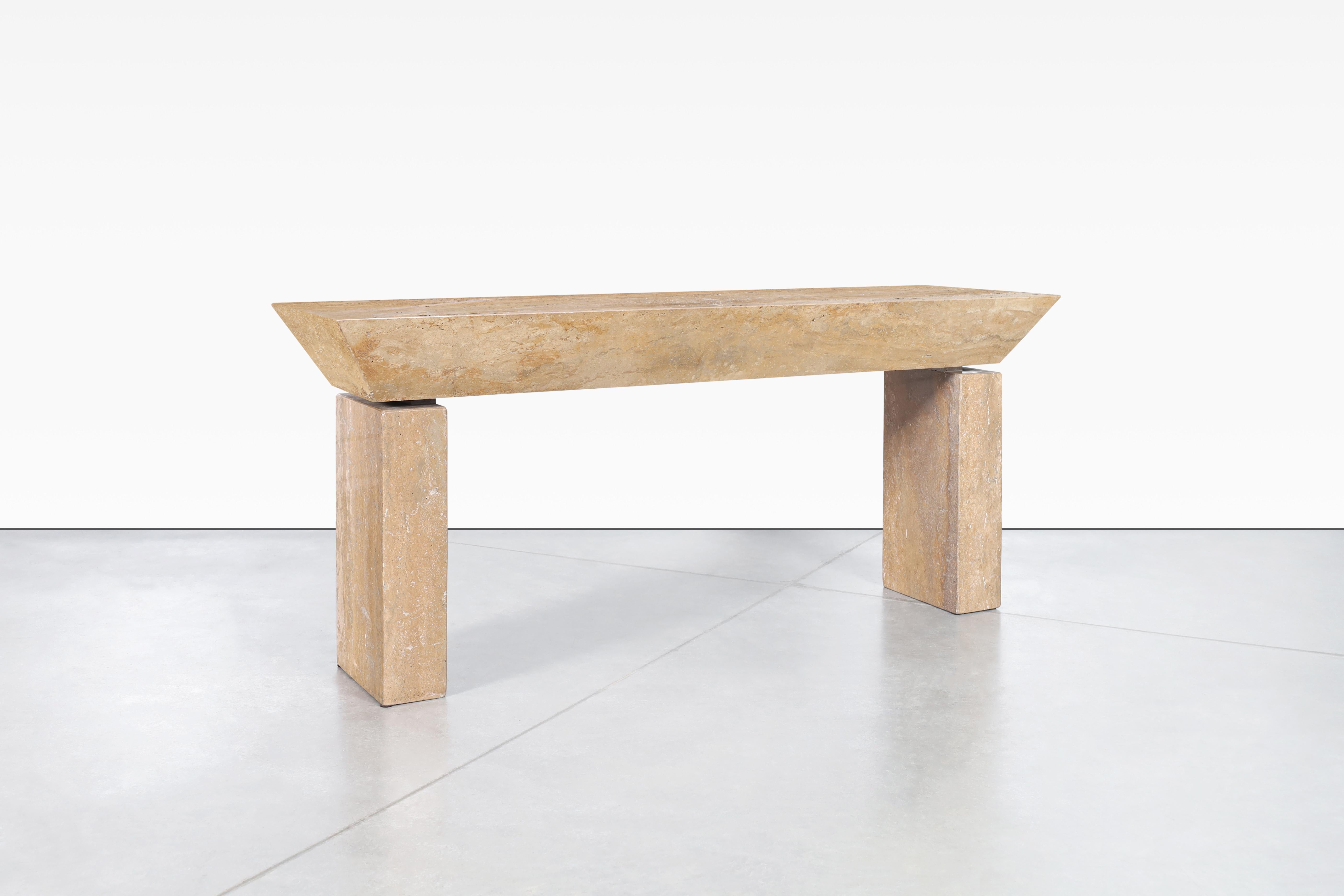 Wonderful Italian modernist travertine console table designed in Italy. The modernist design is perfectly complemented by the natural minerals of the travertine stone. The table features a rectangular travertine top with an angular cut around the