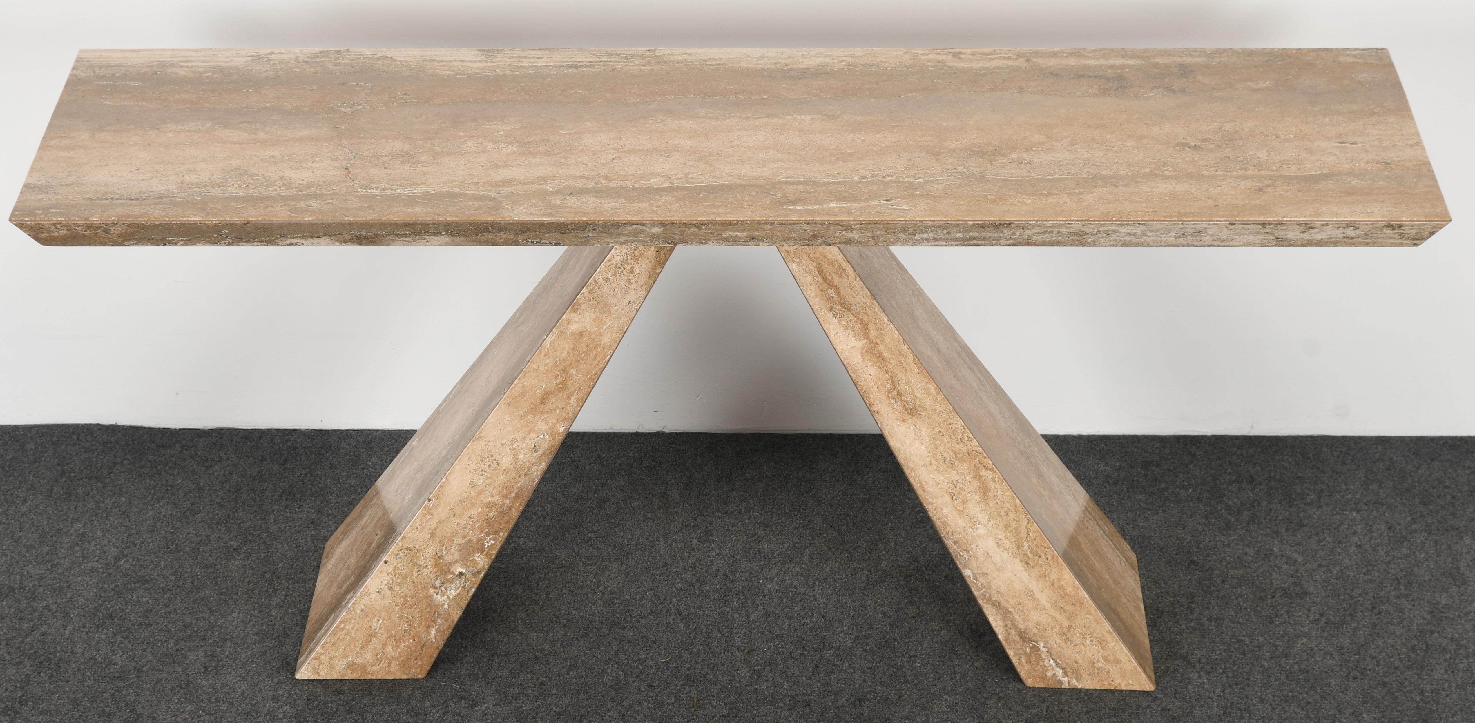 A chic Italian modernist travertine console table. The marble table has beautiful veining throughout the surface. On the backside, there is one filled in grain, as shown in images. The table is structurally sound and in very good
