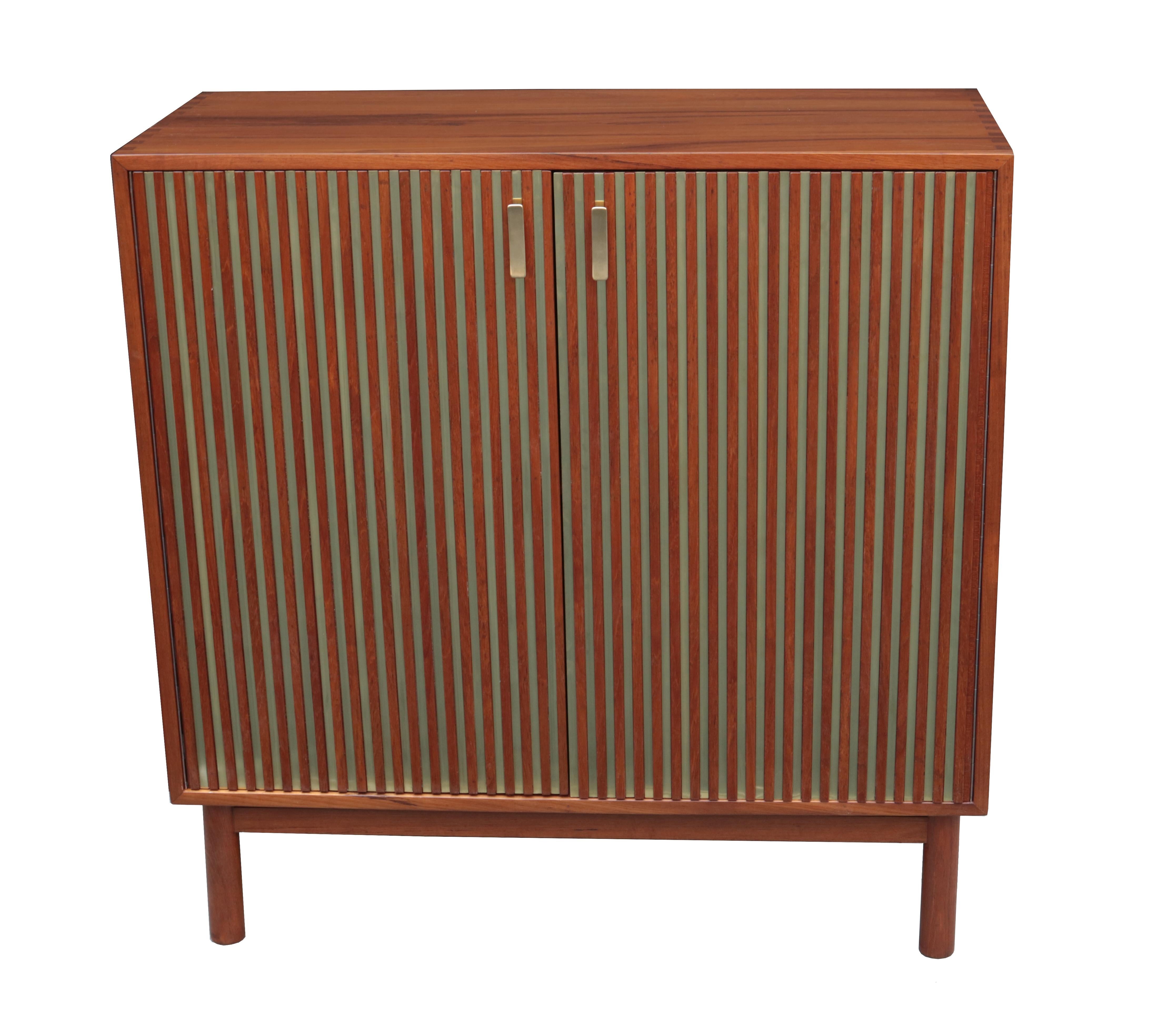 An Italian modernist two-door cabinet.
Mahogany with patinated brass details.
 