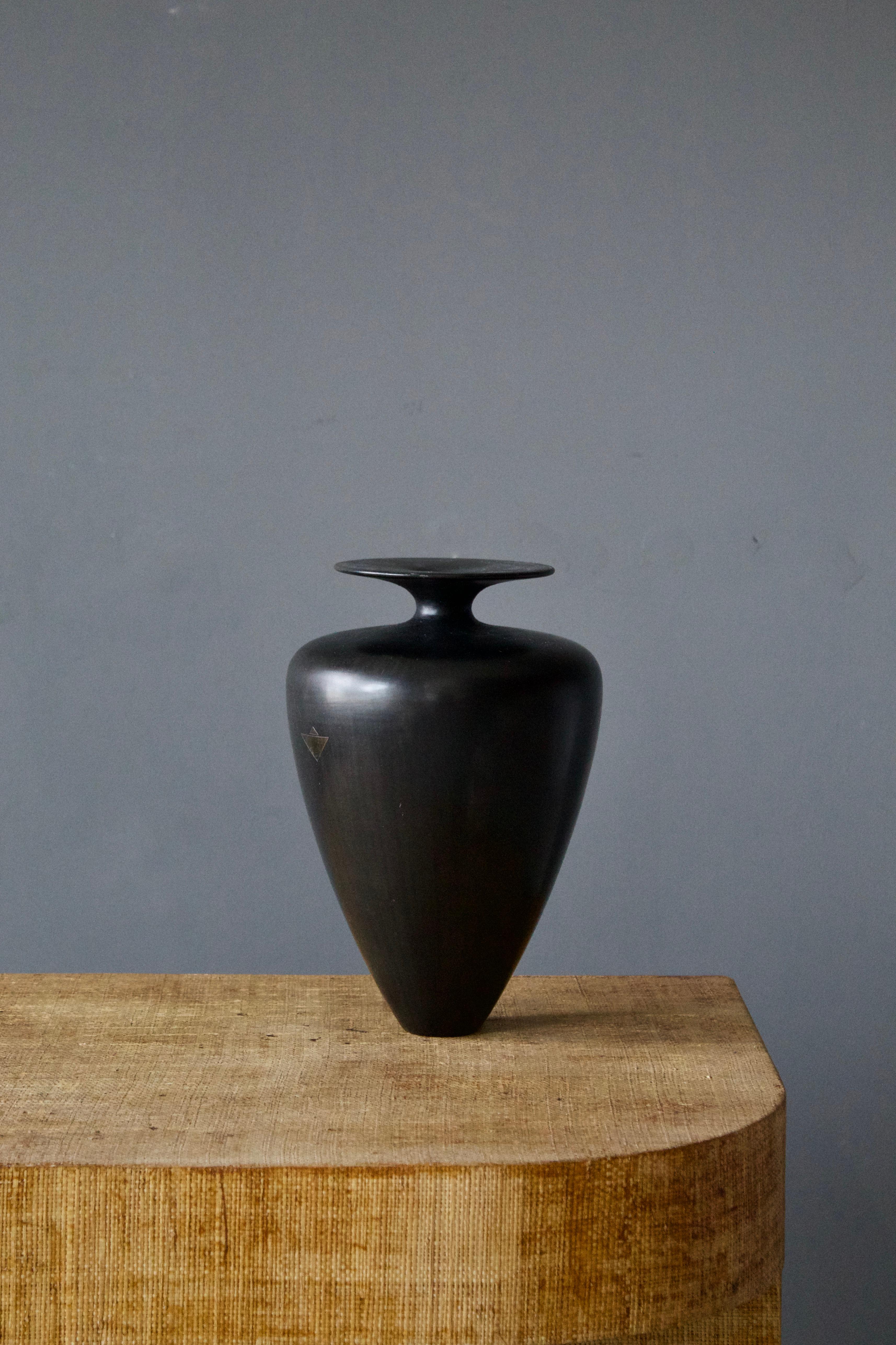 A modernist vase, black glazed ceramic with small metal inlay, Italy, 1940s.