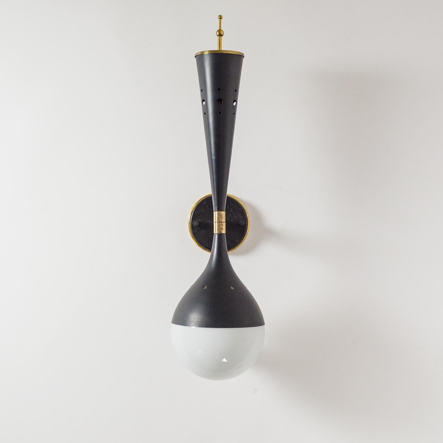 Very unique Italian wall light from the 1950s, attributed to Stilnovo. Dual-cone shape with a cased glass globe on the bottom and a small brass 
