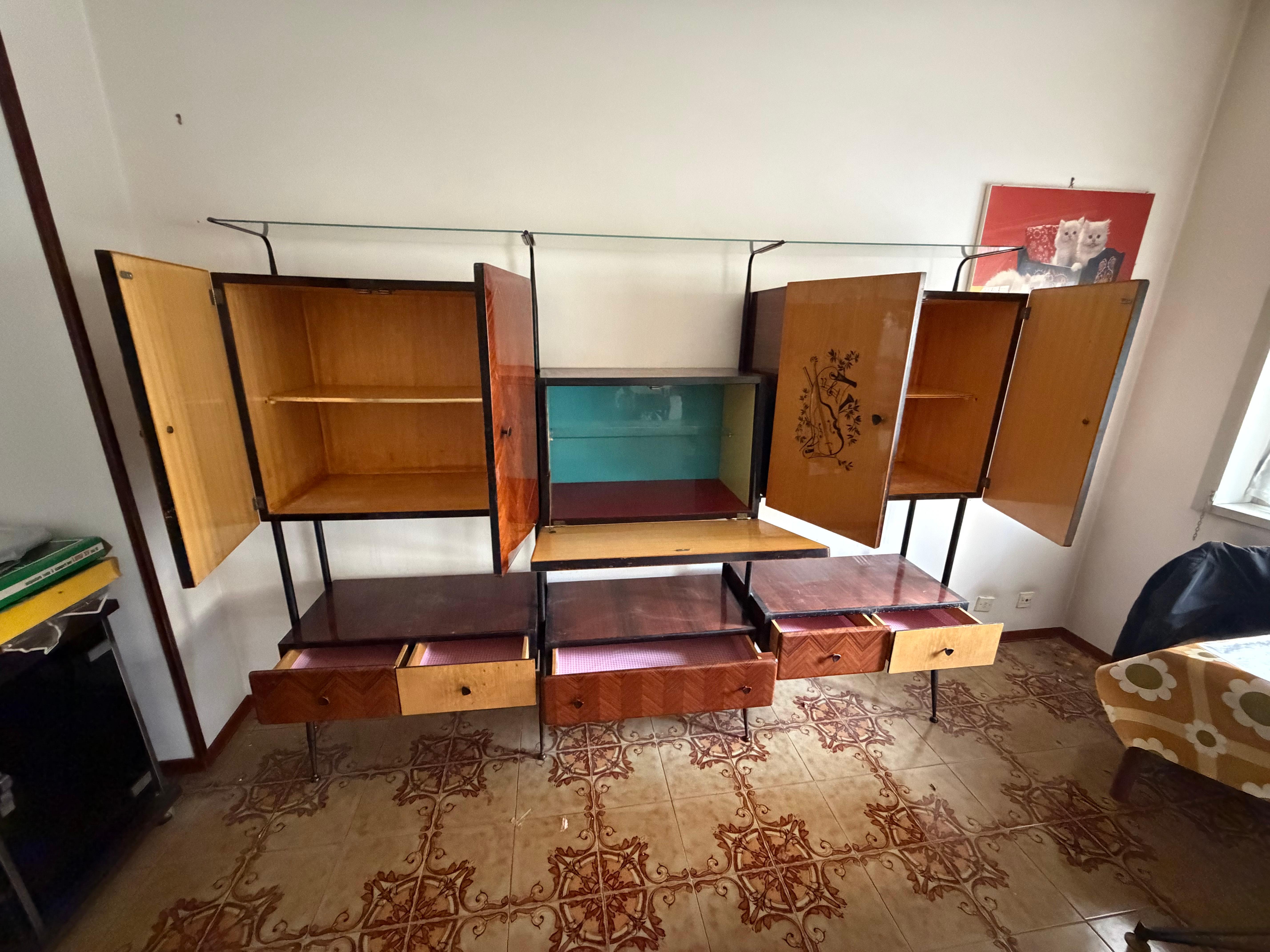 Italian modular cabinet attributed to Silvio Cavatorta, 1960s
Enamelled aluminum and brass handles, metal frame, glass top.
Good condition, minor signs of wear.

Width 235 cm, depth 40 cm, height 174 cm.
