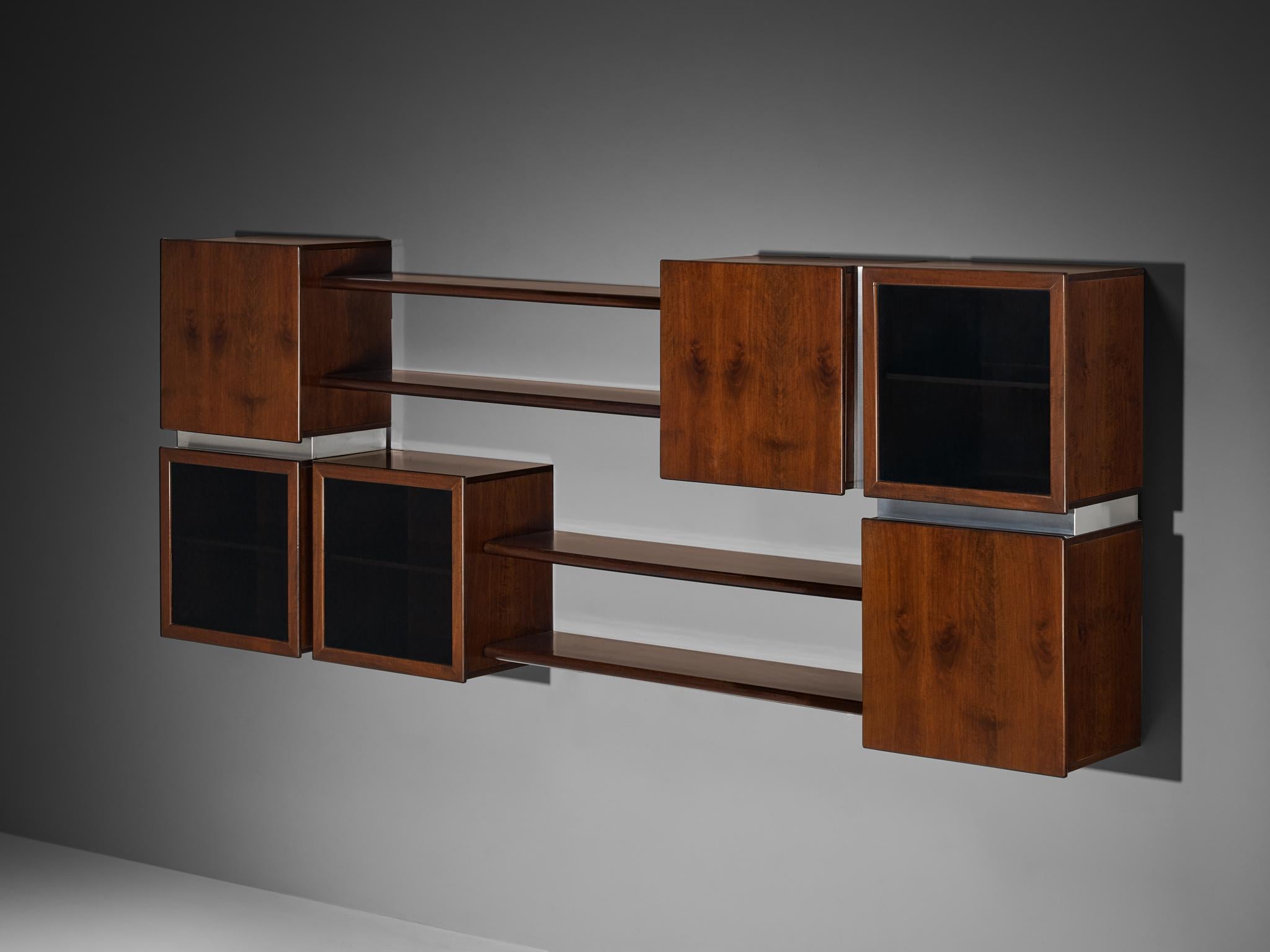 Modular shelving wall unit, walnut, stainless steel, smoked glass, Italy, 1970s

Designed and made in Italy, a streamlined bookcase that is meant to be affixed to the wall. The construction is composed of closed compartments and horizontal open