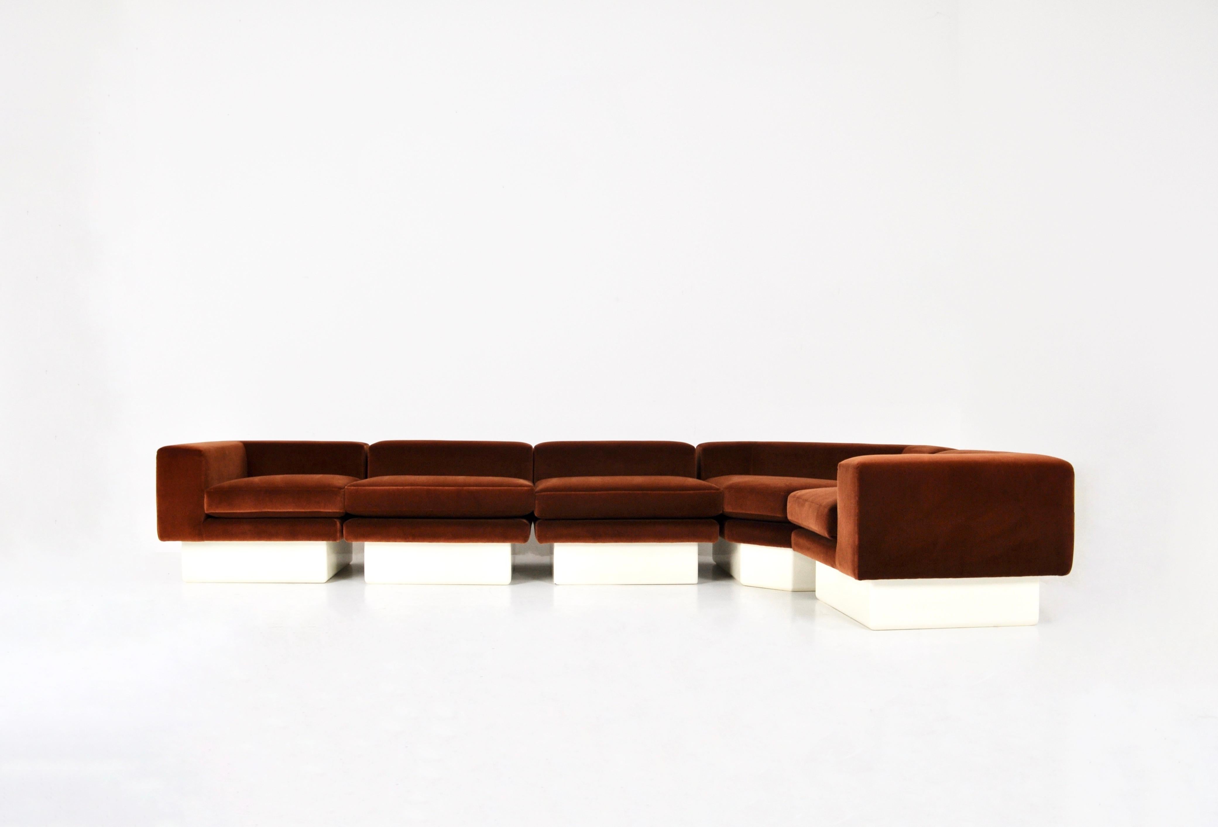 Modular sofa in brown suede and wood. Seat height 43 cm. One-piece dimensions: H: 60 cm W: 81 cm D: 81 cm. Corner dimensions: H: 60 cm W: 143 cm D: 81 cm. Wear due to time and age of sofa.

