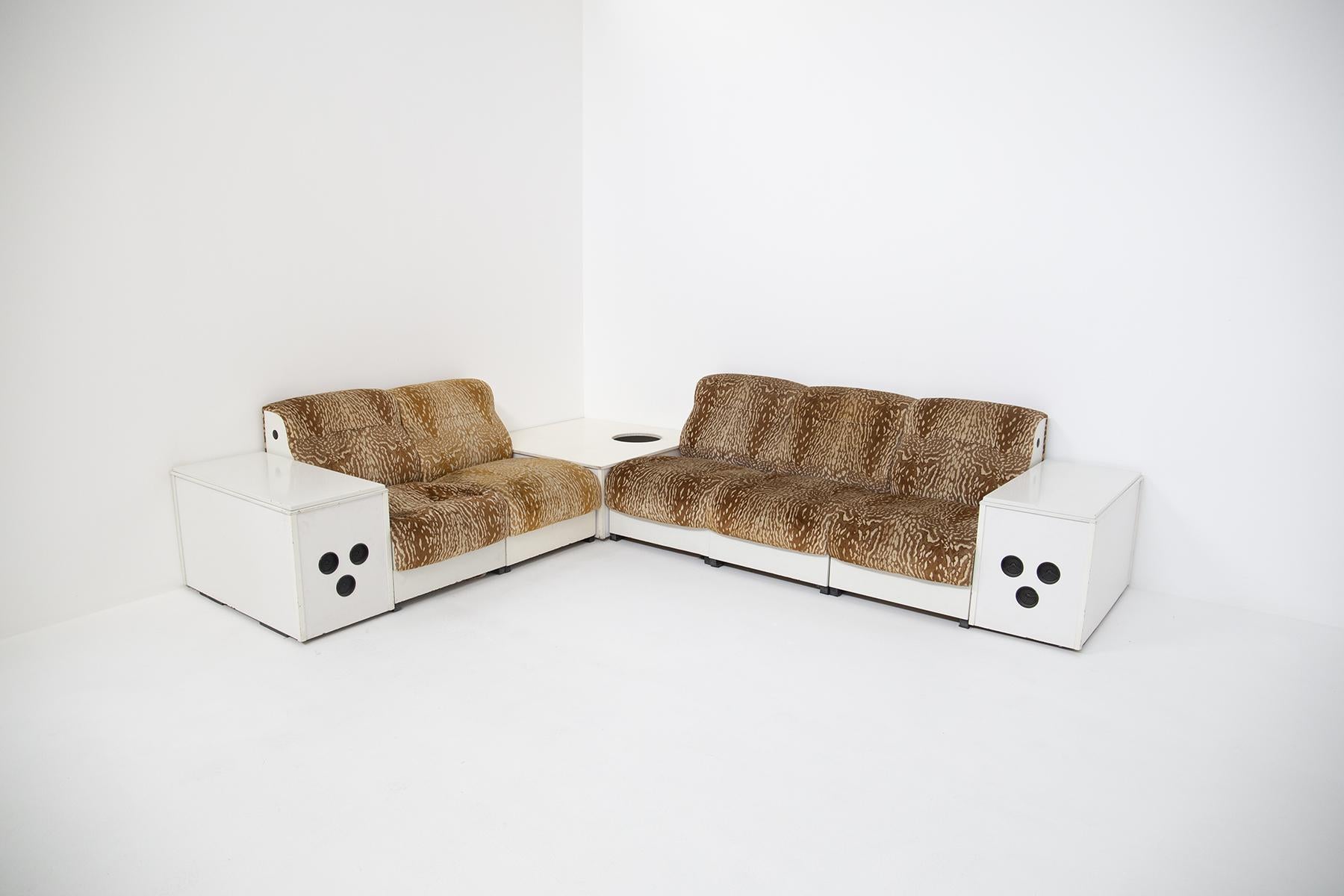Italian Space Age sofa from the 1970s. The sofa is in its original condition even the fabric is original of the time. The sofa is modular and is ideal as a corner sofa. The peculiarity of the sofa is that at its sides are two cabinets ideal as a