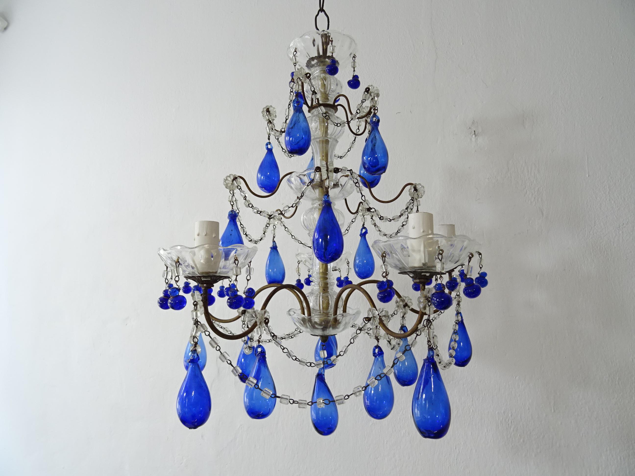 Housing 5 lights, sitting in crystal bobeches, dripping with vintage cobalt Murano glass tiny drops. This chandelier will be rewired with certified UL US sockets for the United States and appropriate sockets for all other countries and ready to