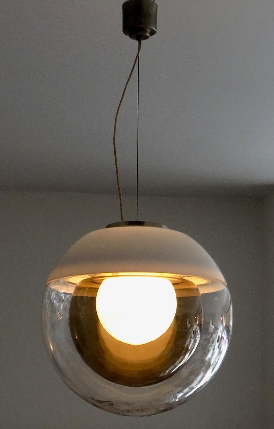 Italian multi globe glass pendant chandelier light.
The fixture is made up of three concentric glass globes.
First a centre cased white glass core globe that holds the single light source.
Second, a dark amber/brown translucent globe.
Third, the