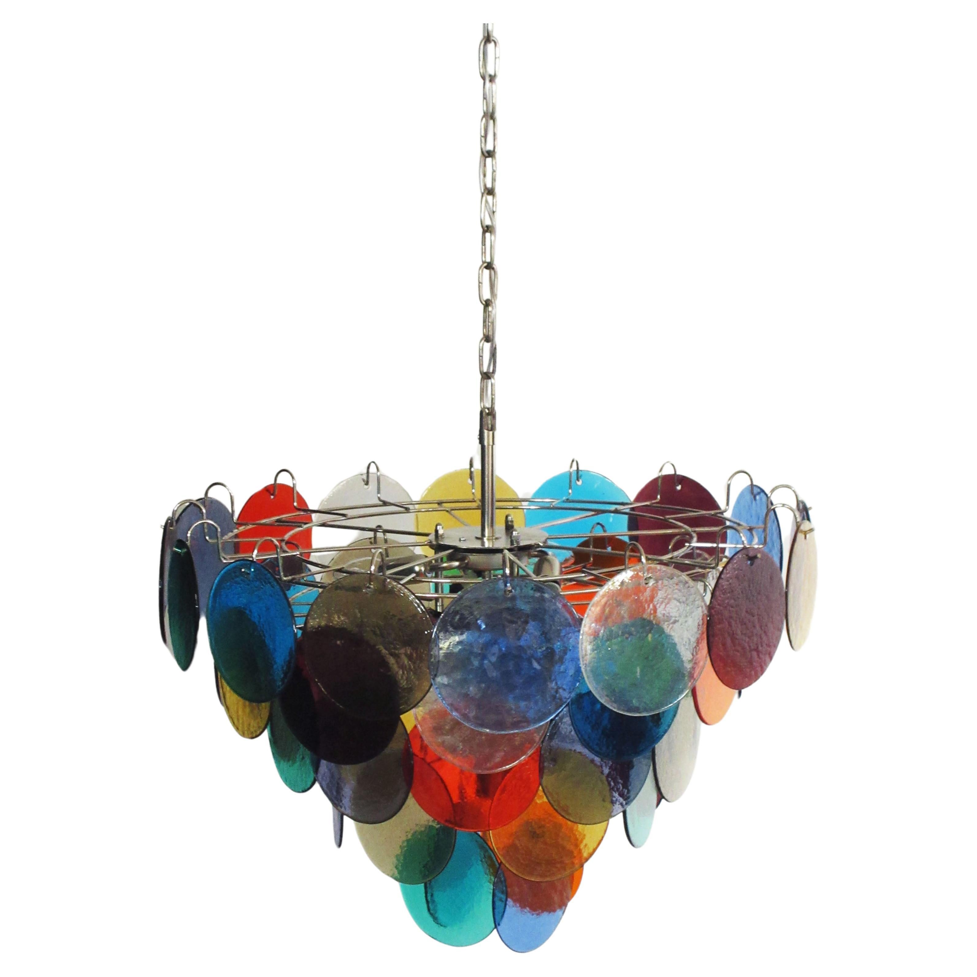 Each chandelier has 50 Murano multicolored glass disks. The glasses are now unavailable, they have the particularity of reflecting a multiplicity of colors, which makes the chandelier a true work of art. Nickel metal frame.
Period: