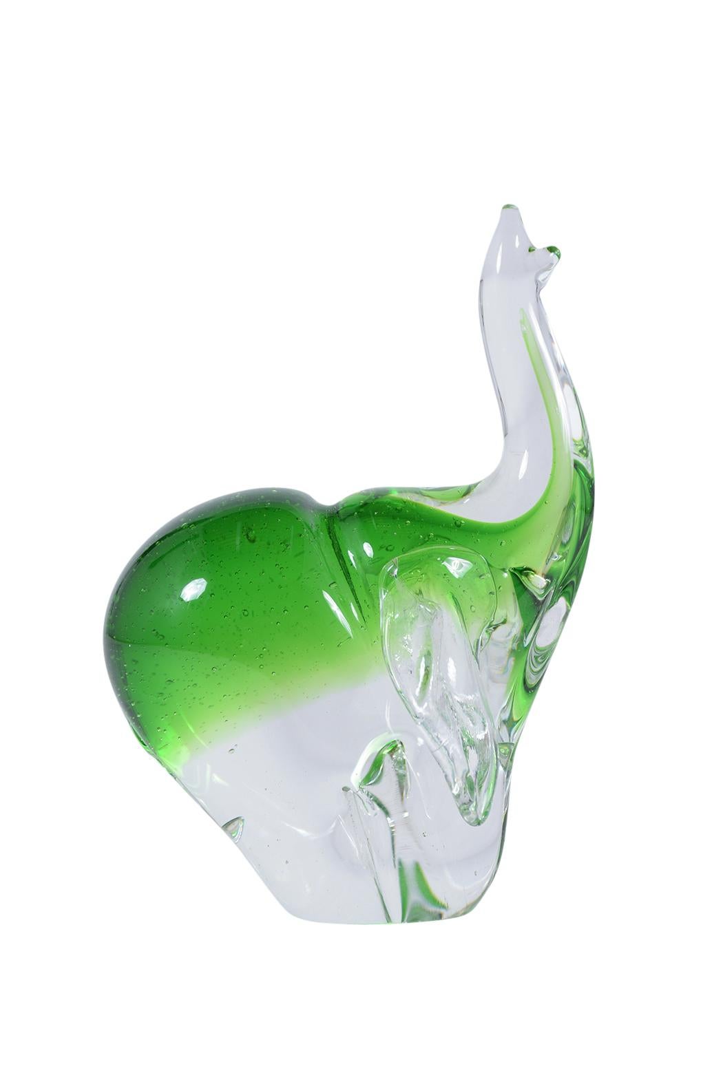 This 1960's Italian sculpture hand-crafted out of Murano glass depicting an elephant in a clear and green color combination. This sculpture is in great condition and has no scratches or chips. This piece is a perfect addition for a home or office