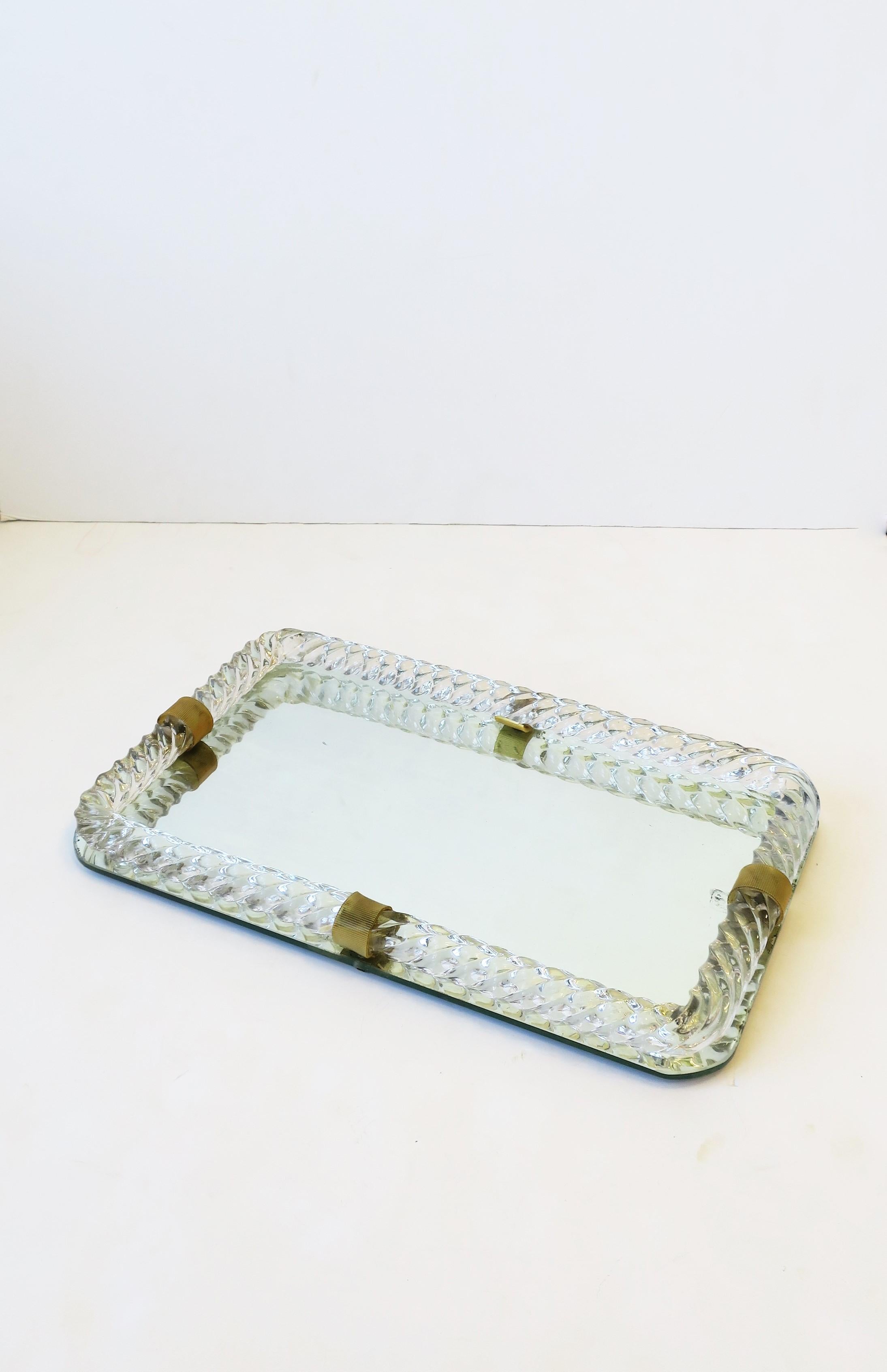 A beautiful Italian Murano art glass and mirror vanity tray, in the style of Venini, circa mid-20th century, Italy. Beautiful and substantial twisted Murano art glass with celluloid loop detailing and mirrored base. A special piece to hold jewelry,