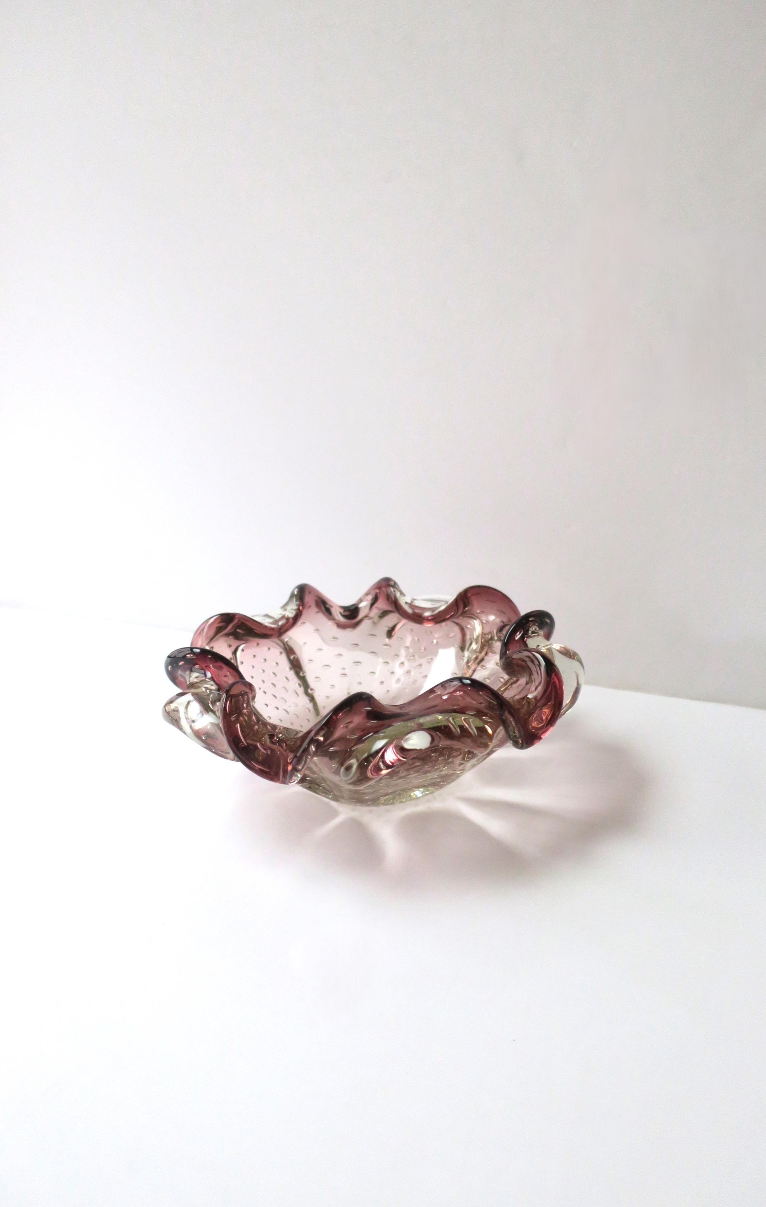 A beautiful and substantial vintage Italian Murano burgundy/plum/aubergine and transparent art glass bowl with a controlled bubble design, Midcentury Modern design period, circa mid-20th century, Italy. Great as a standalone piece on a cocktail