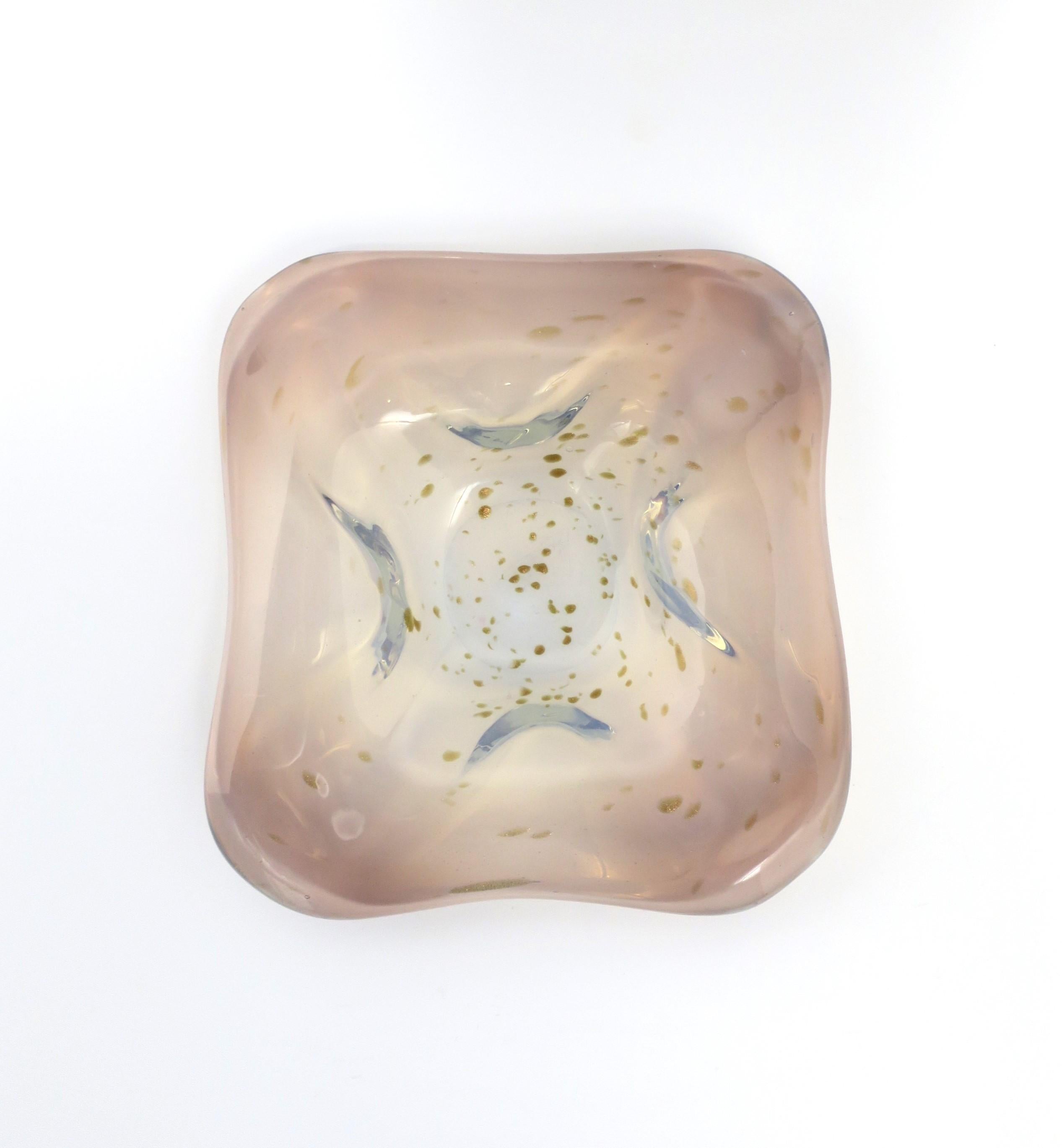 A beautiful and substantial Italian Murano art glass bowl of white opaline, pink, light blue hues and drops of shimmering gold, Midcentury Modern period, circa mid-20th century, Italy. Bowl has an organic modern form to it. Beautiful as a standalone