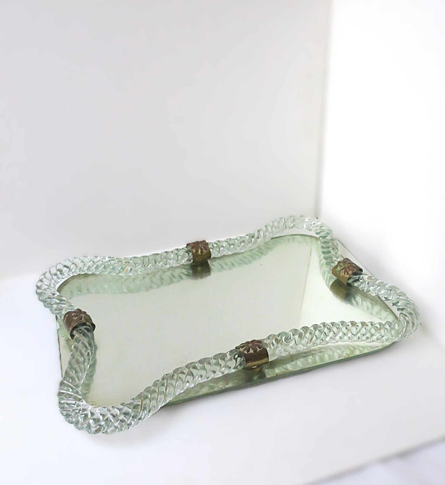 A beautiful Italian Murano art glass and mirror vanity tray, attributed to Venini, circa early to mid-20th century, Italy. Italian Modern/Midcentury Modern design period. Beautiful and substantial twisted Murano art glass with brass loop detailing