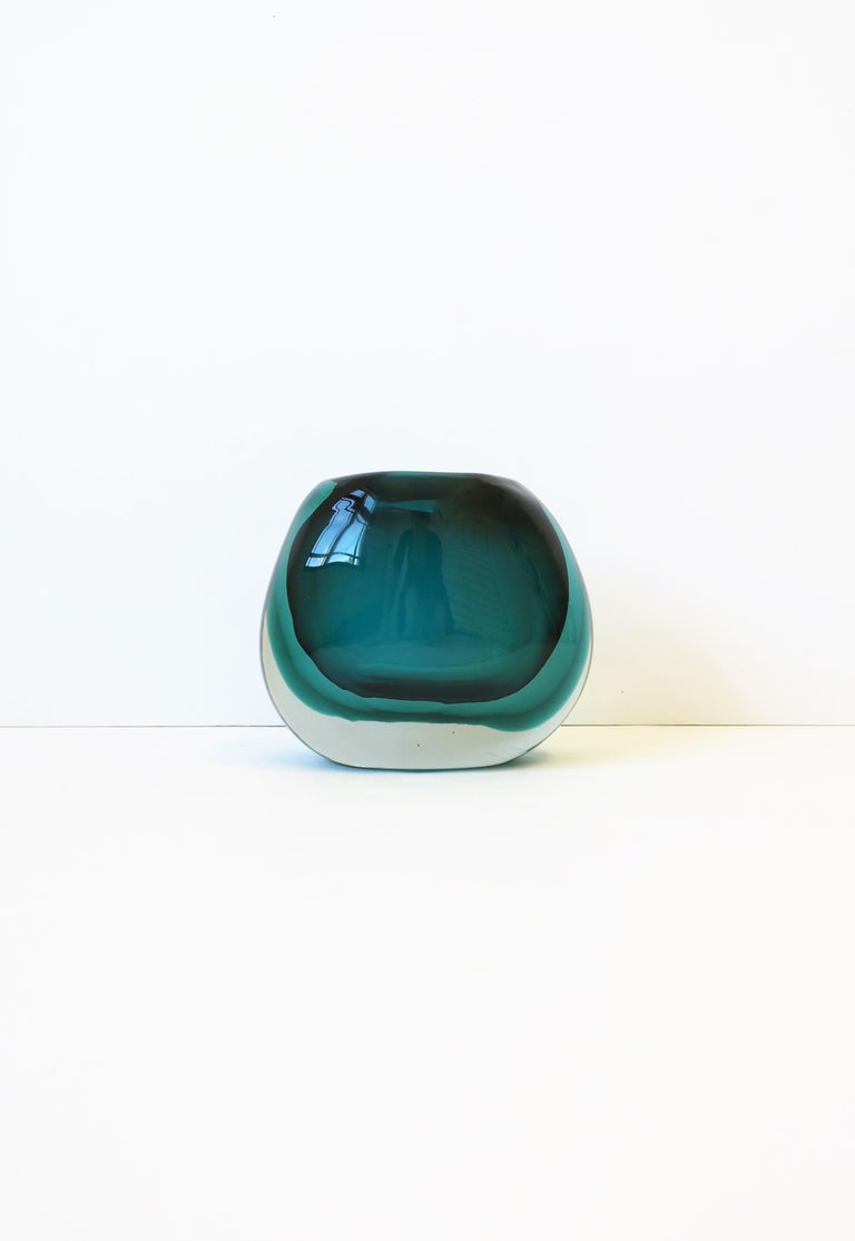 A beautiful and substantial Italian Murano art glass vase in Emerald green in the style of Flavio Poli, circa late-20th century, Italy. Vase is two shades of emerald green and clear/transparent art glass, in an oval shape. Three layers of 'Sommerso'