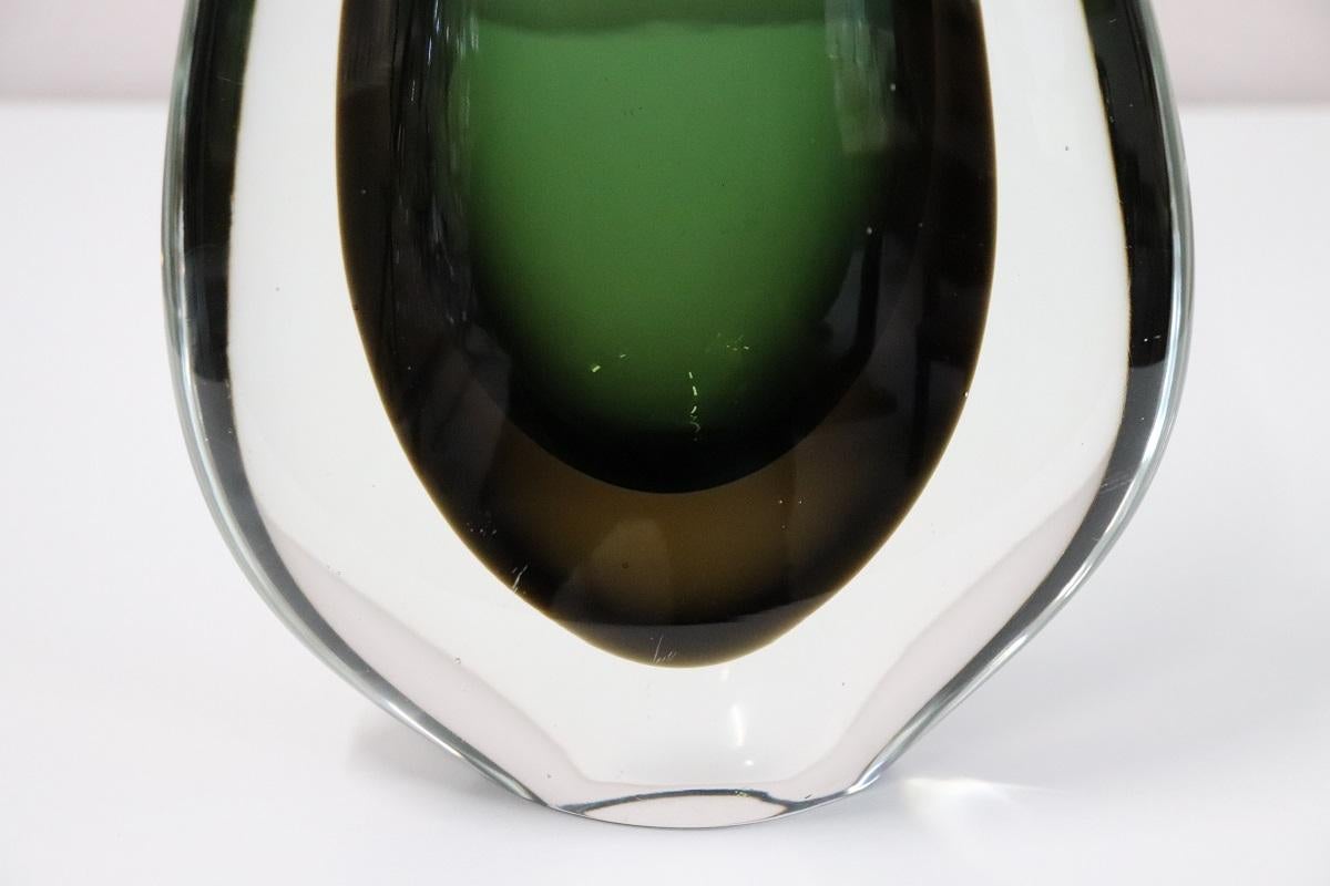 Refined large artistic Murano glass vase in shades of green made by Flavio Poli for Seguso, 1960s. This vase is characterized by a particular design shape. Made with green blown glass inside the transparent glass. The processing technique is called