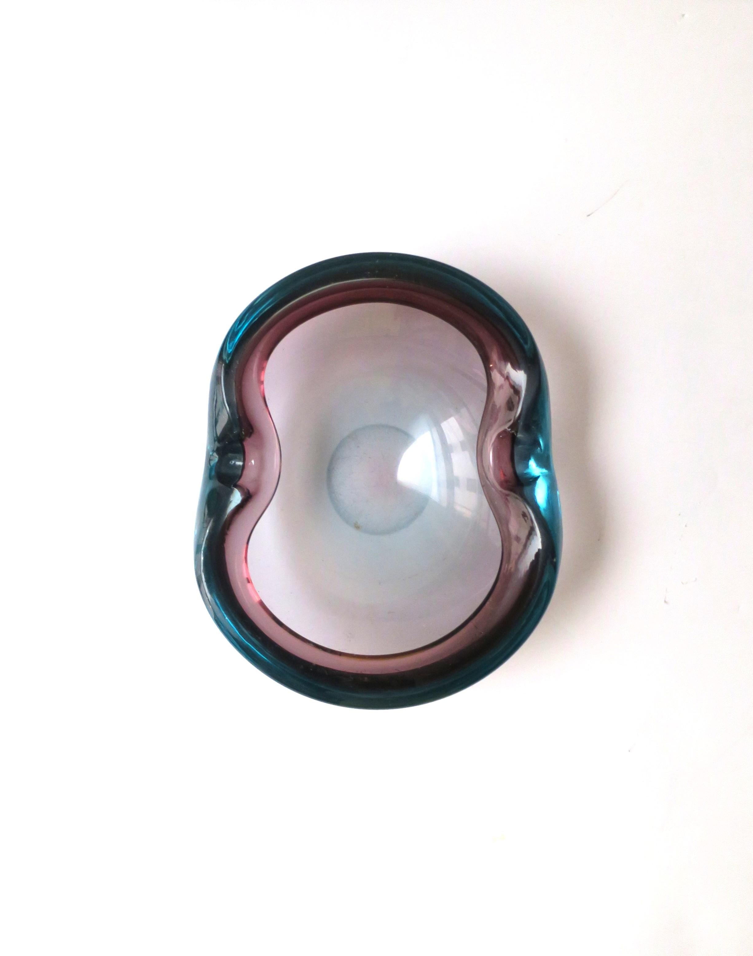 A substantial vintage Italian Murano hand blown Sommerso art glass bowl or ashtray in the style of artist Alfredo Barbini, Midcentury Modern period, circa 1950s, 1960s, Italy. Piece is blue and amythest art glass, oval in shape, with two indents on