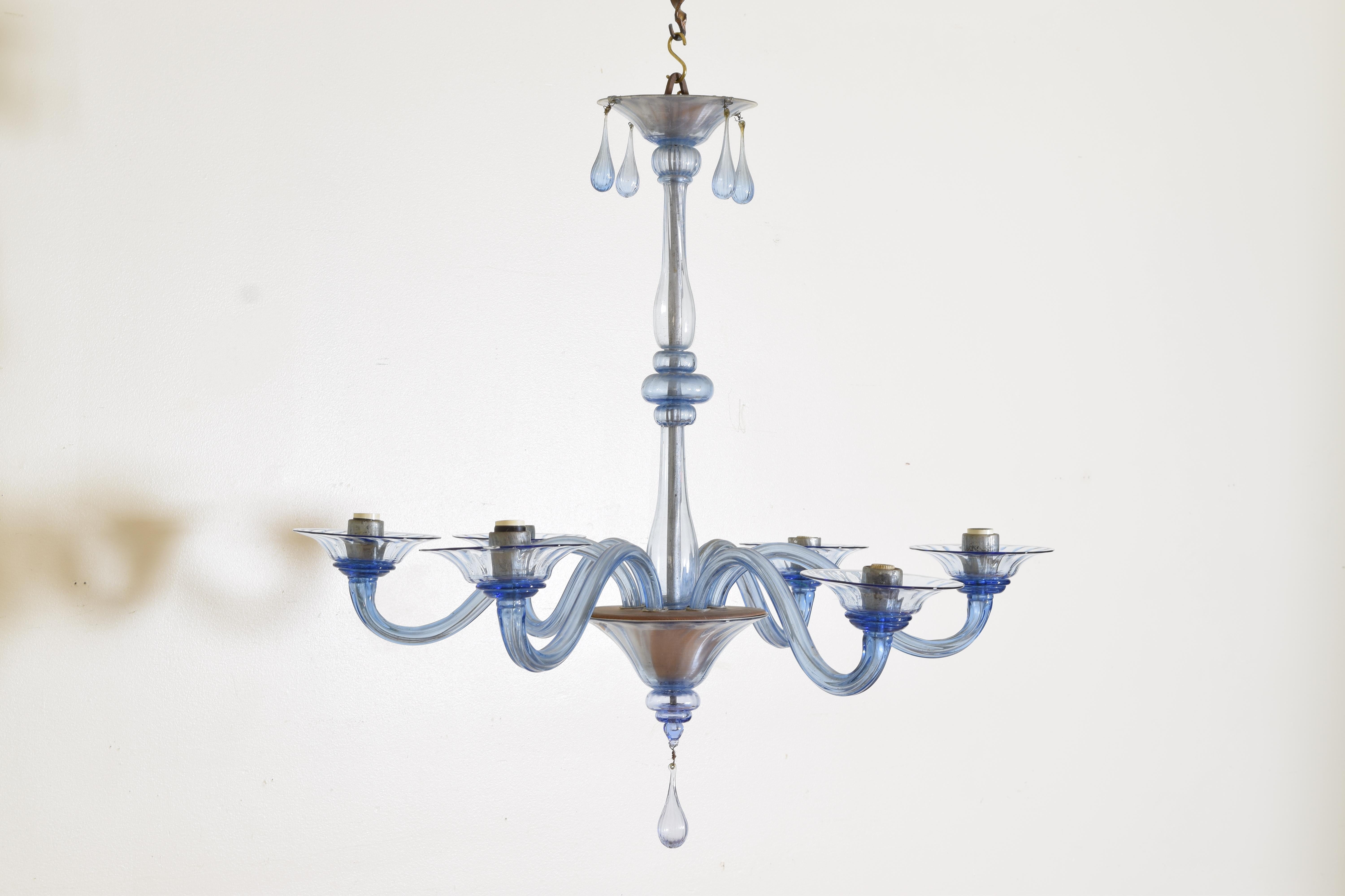 Constructed of multiple blown glass pieces the canopy section with four glass tassels atop a standard of straight glass rods and balls, the lower section issuing six arms and having a tassel terminal